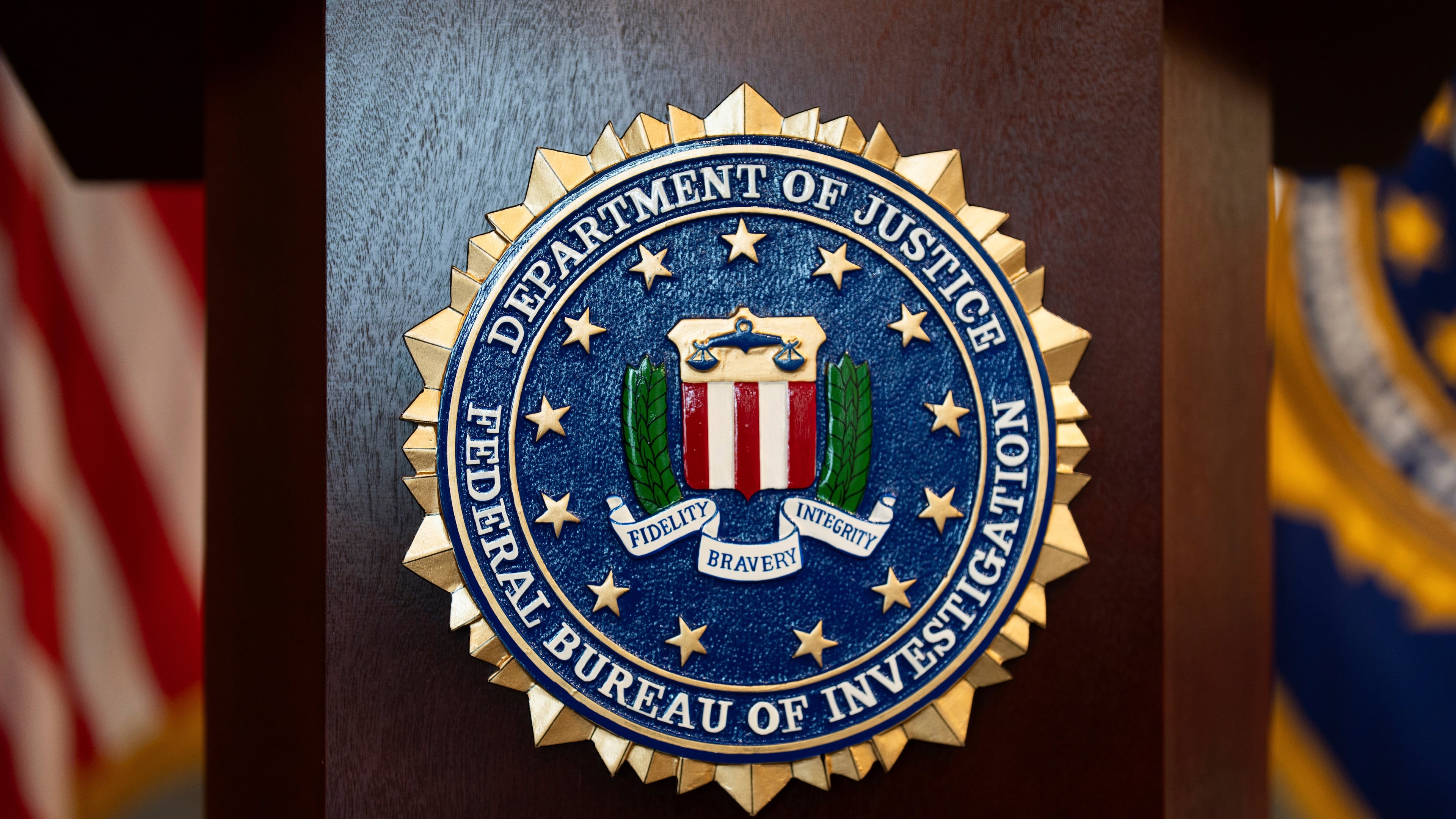 FILE - An FBI seal is displayed on a podium before a news conference at the field office in Portland, Ore., Jan. 16, 2025. (AP Photo/Jenny Kane, File)