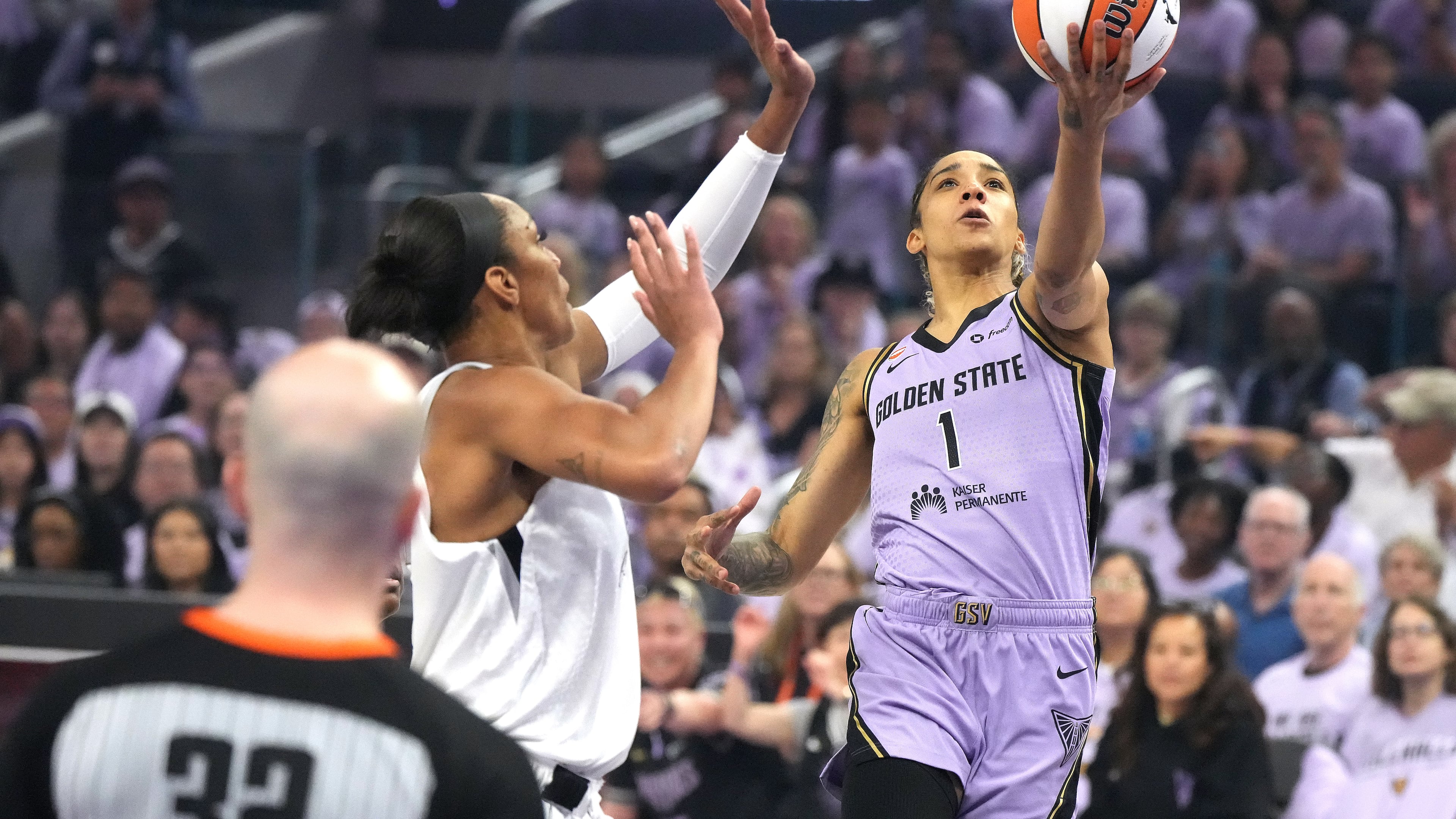 Golden State Valkyries forward Gabby Williams (1) drives to the basket against Las Vegas Aces center A'ja Wilson, second from right, during the first half of Game 1 of the WNBA basketball semifinals in San Francisco, Sunday, Oct. 4, 2026. (AP Photo/Tony Avelar)