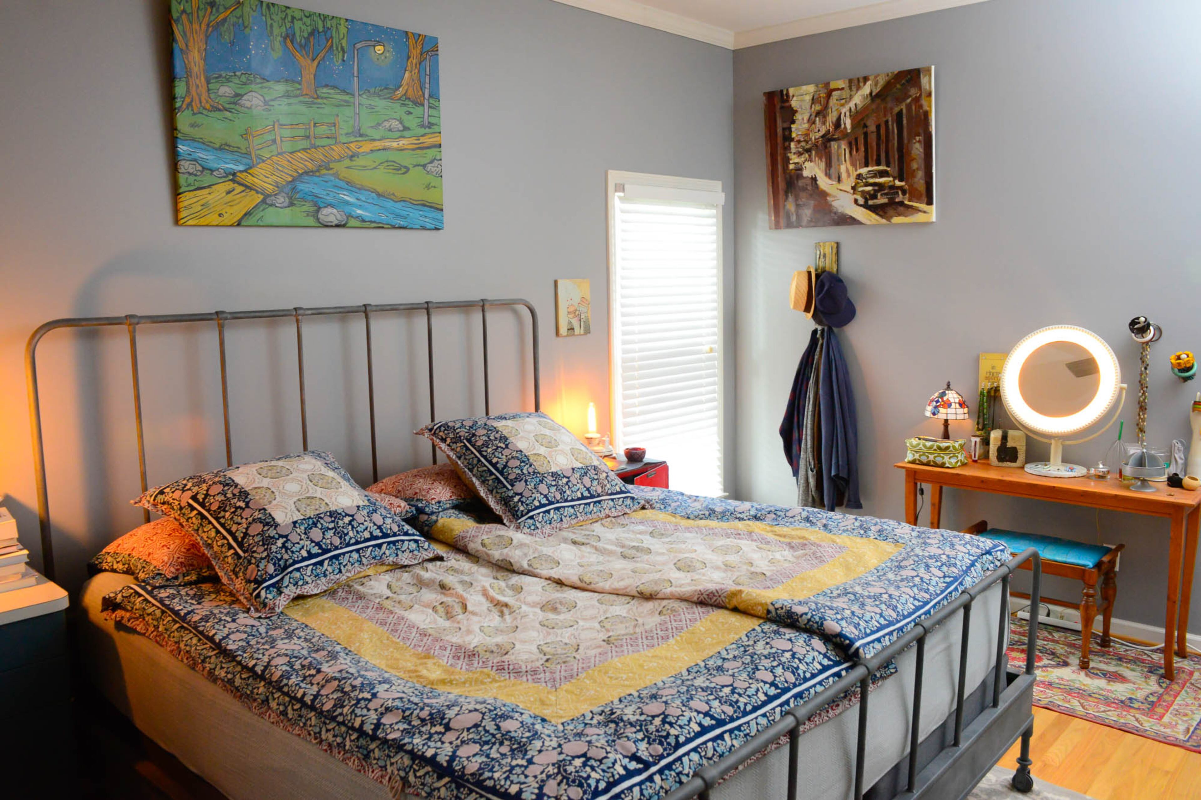 Bedding from Anthropologie tops the bed from RH. Art hanging above the bed, by R. Land, is from the first show that Gillese directed.
