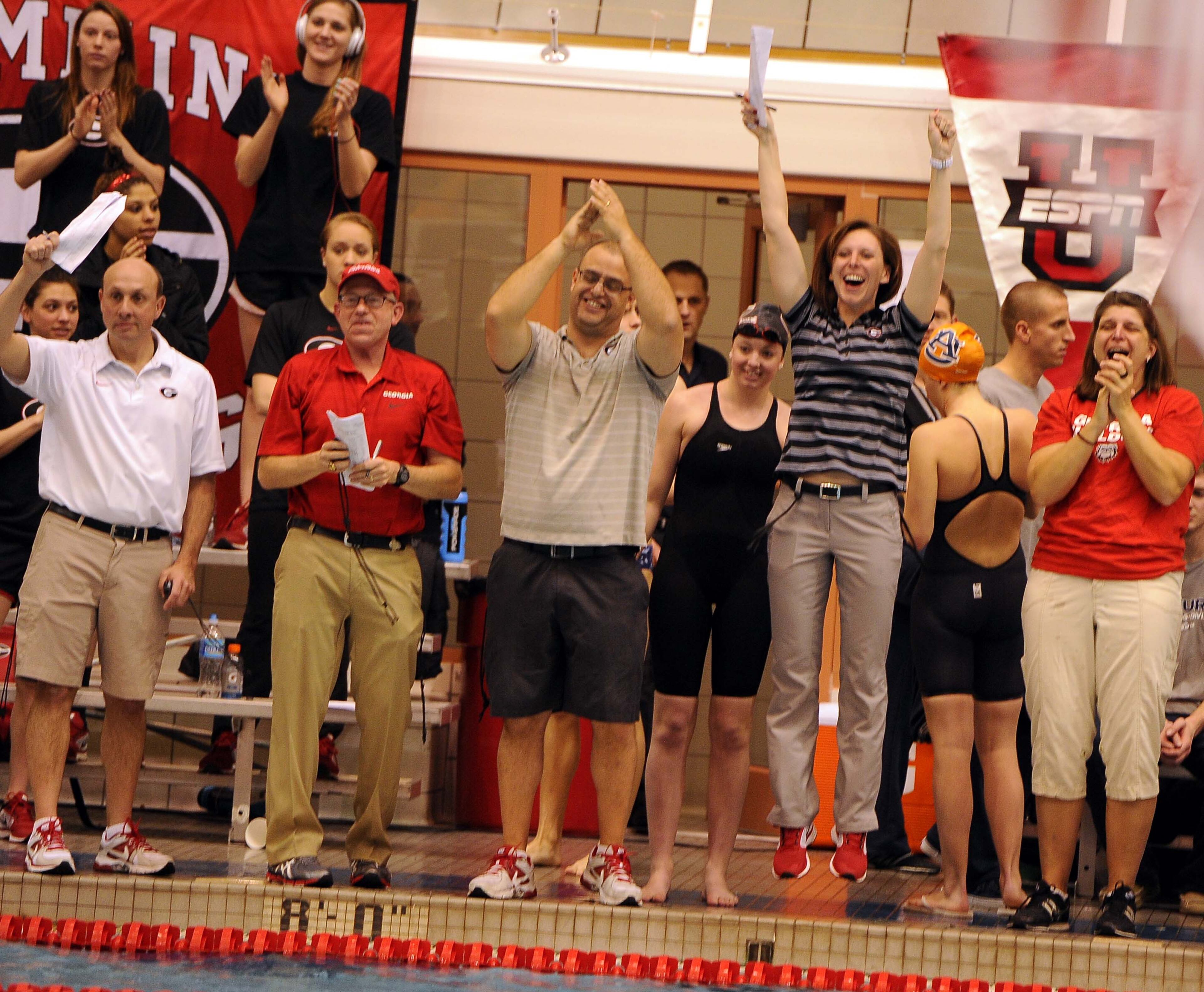 Georgia coaches like the results during day five of the SEC Swimming and Diving Championships prelims held at the Gabrielsen Natatorium on Friday, Feb. 22, 2014 in Athens, Ga.
