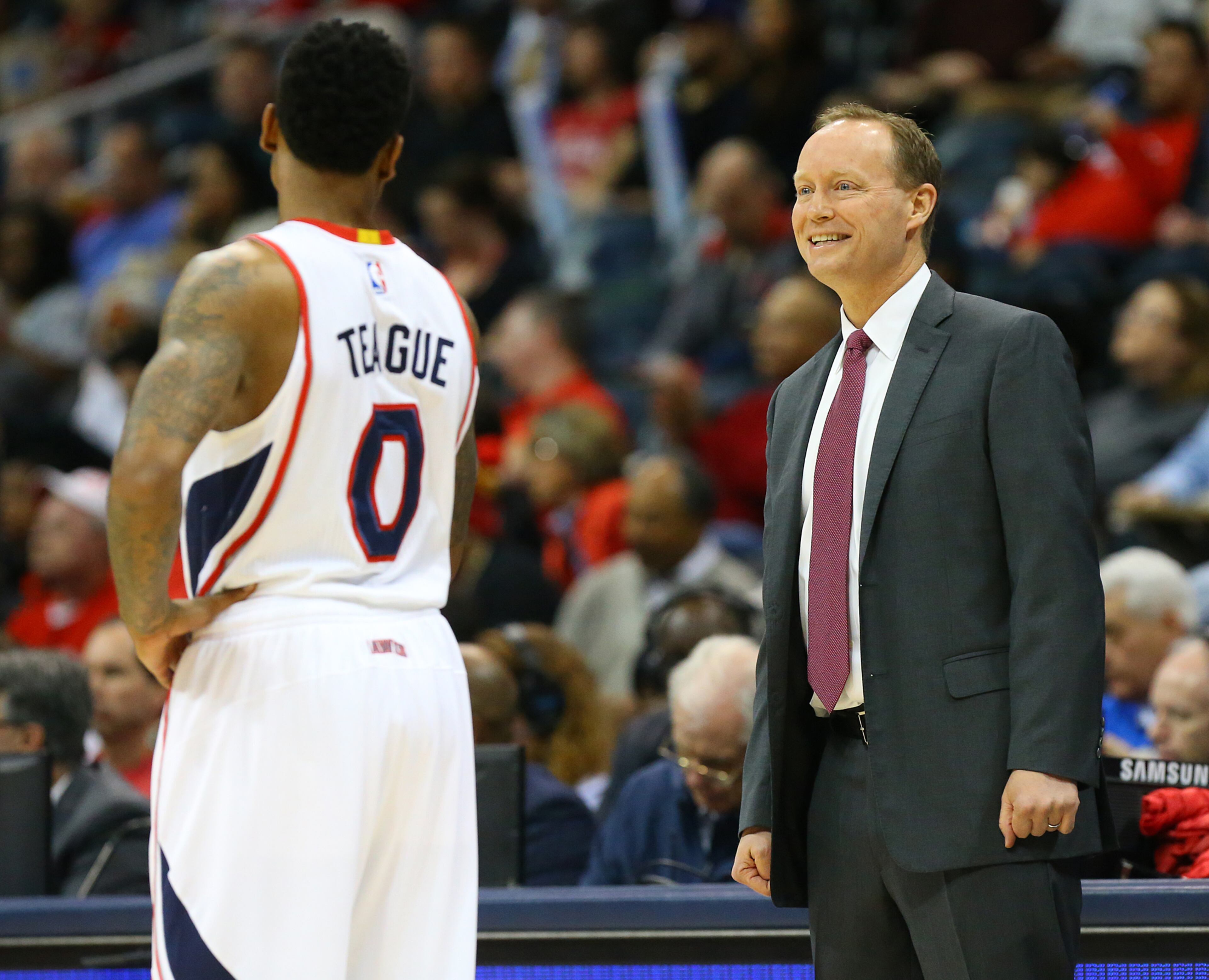 Hawks coach Mike Budenholzer shares a laugh with Jeff Teague on Wednesday, Jan. 21, 2015 in Atlanta. Curtis Compton / ccompton@ajc.com