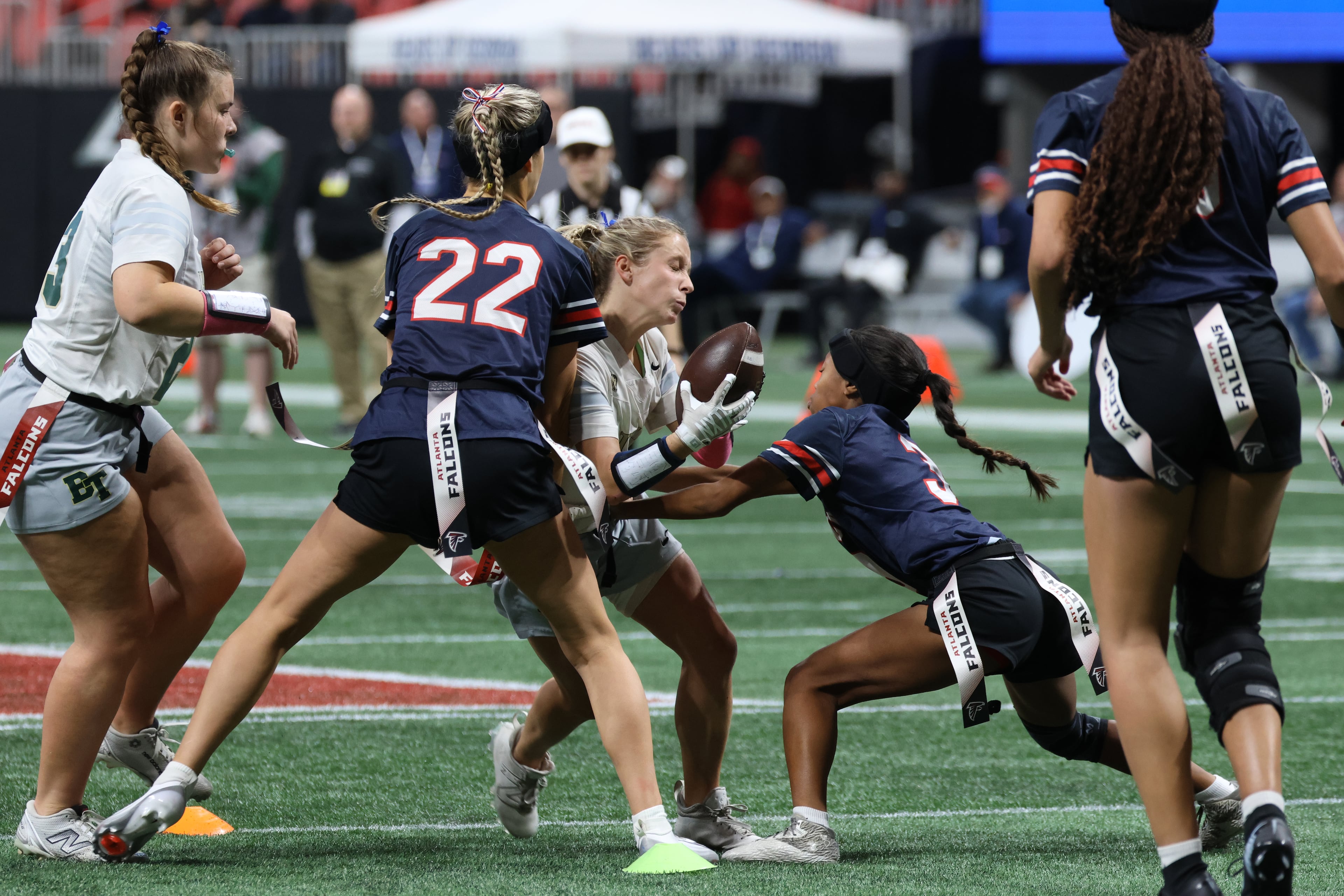 Blessed Trinity’s Maggie Sullivan gets tied up by Milton defenders during the flag football Division 4 championship match between Milton and Blessed Trinity in Atlanta, Georgia on Tuesday, December 16, 2025. (Addison Simmons for the AJC)