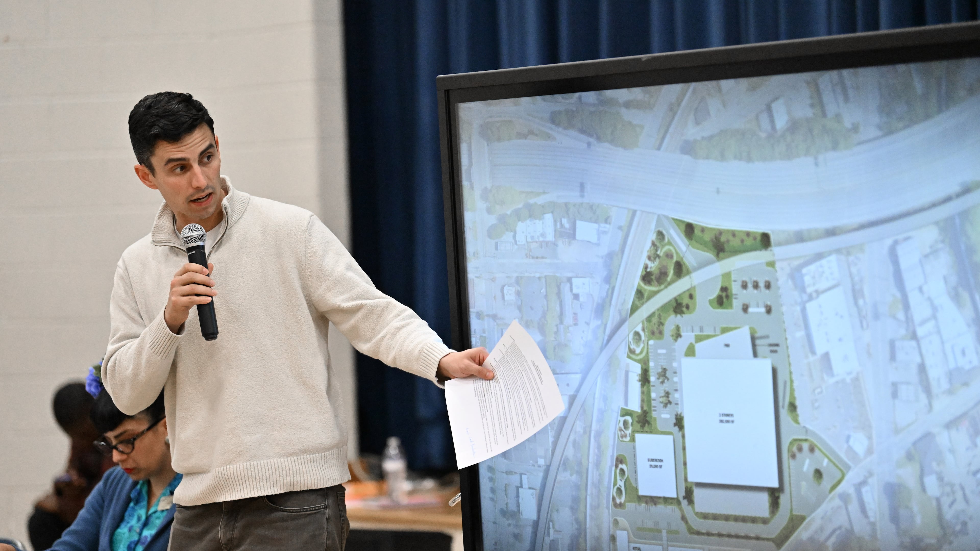 Andrew Alves, Digital Realty’s senior vice president of acquisitions, speaks during a town hall by NPU-V and Digital Realty to discuss a planned data center in Atlanta at Dunbar Elementary School, Thursday, March 19, 2026, in Atlanta. (Hyosub Shin/AJC)