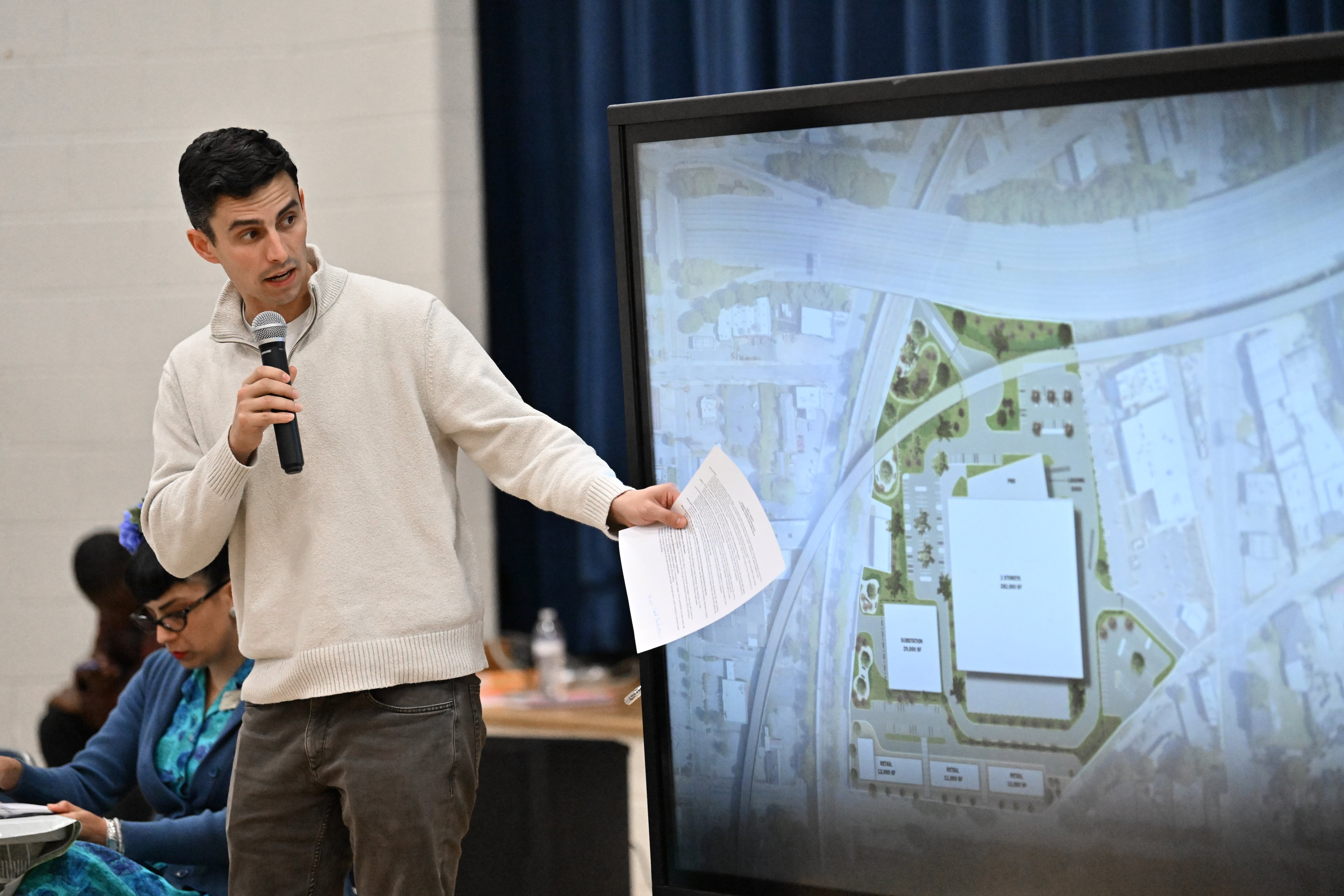 Andrew Alves, Digital Realty’s senior vice president of acquisitions, speaks during a town hall by NPU-V and Digital Realty to discuss a planned data center in Atlanta at Dunbar Elementary School, Thursday, March 19, 2026, in Atlanta. (Hyosub Shin/AJC)