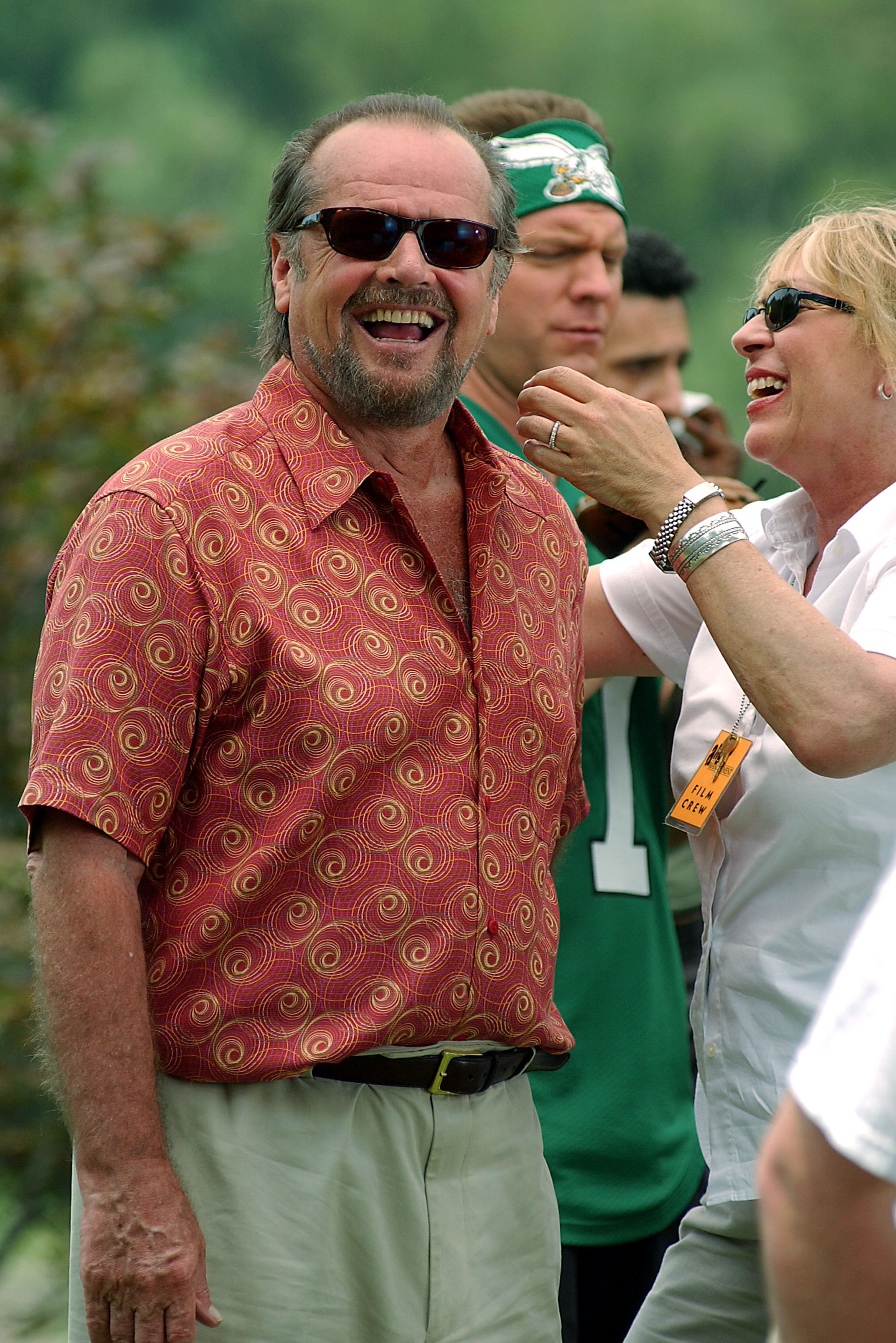 Actor Jack Nicholson shares a joke with a makeup artist on the set of the film "Anger Management" on July 1, 2002, at Central Park in New York City.