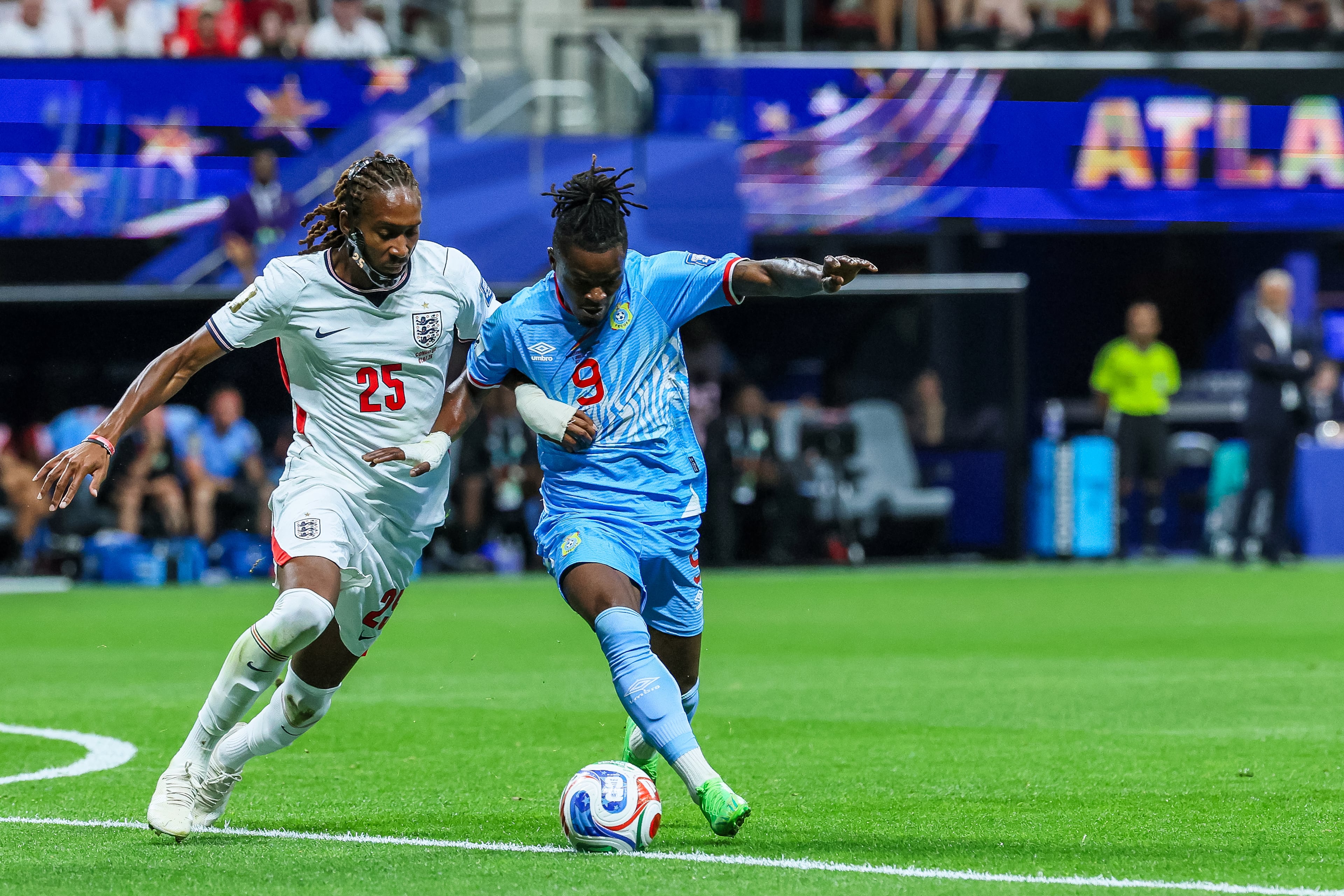 Congo forward Brian Cipenga (right) and England defender Djed Spence (left) battle for control during the first half of a FIFA World Cup round of 32 match at Atlanta Stadium (Mercedes-Benz Stadium) on Wednesday, July 1, 2026, in Atlanta. (Jason Getz/AJC)