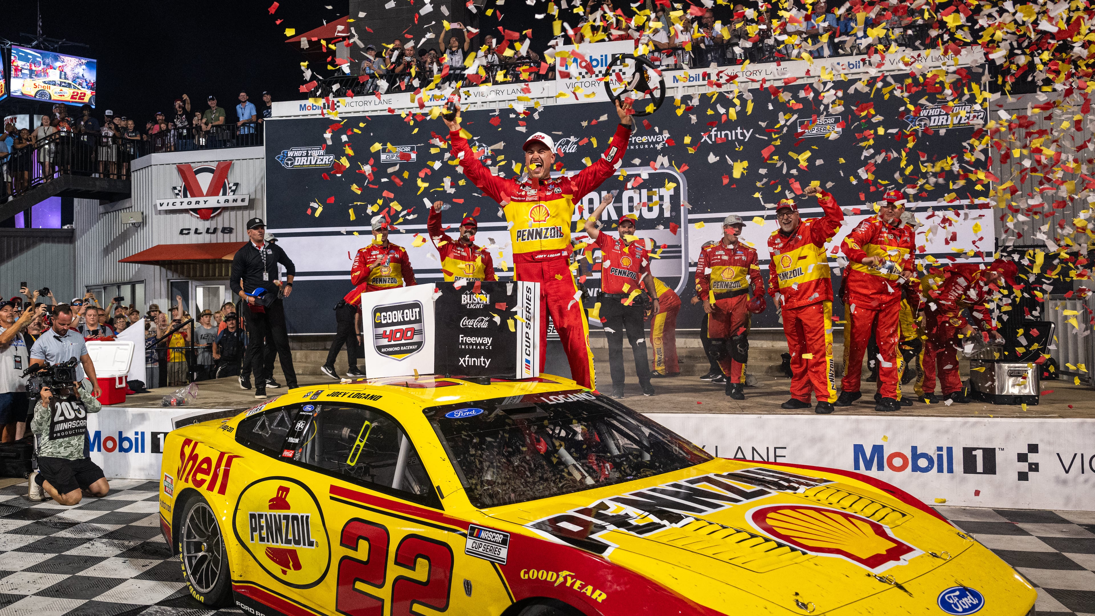 Team Penske driver Joey Logano (22) celebrates in victory lane after winning the Cook Out 400 at Richmond Raceway, Saturday, Aug. 15, 2026, in Richmond Va. (AP Photo/Robert Simmons)