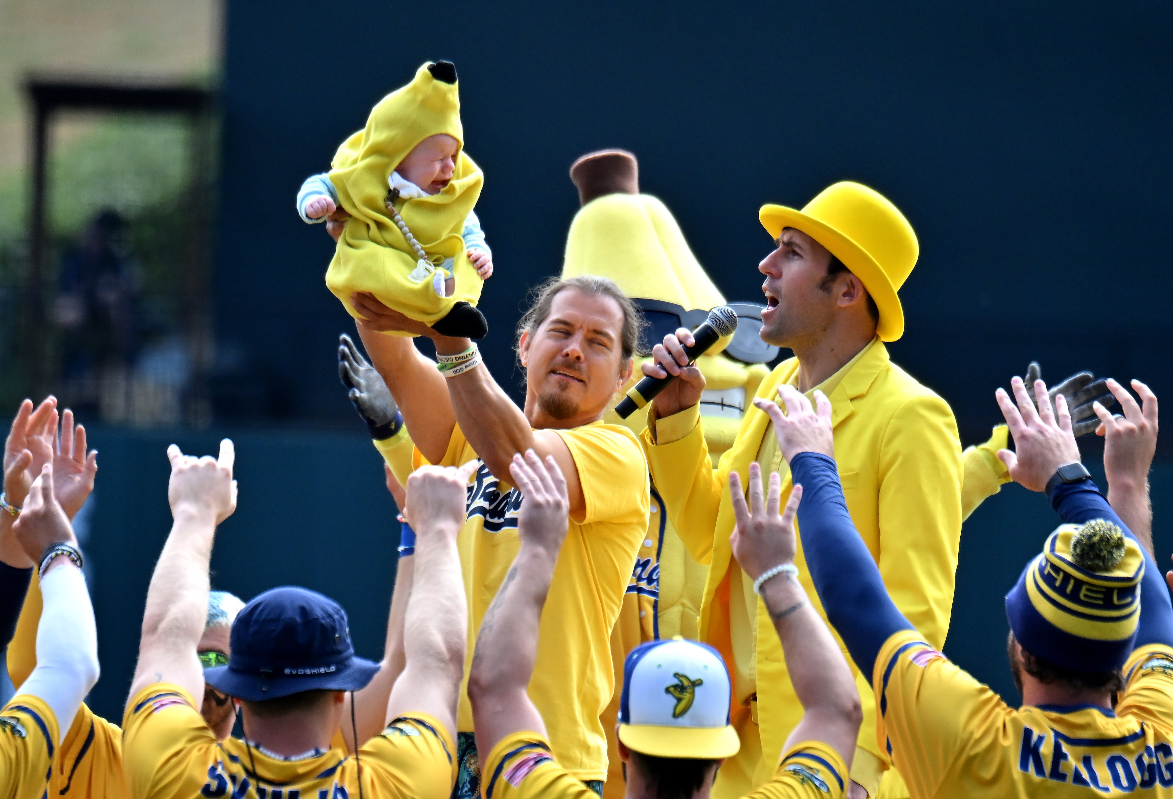 Savannah Bananas owner Jesse Cole and team members welcome a Banana Baby before the game. (Hyosub Shin / Hyosub.Shin@ajc.com)