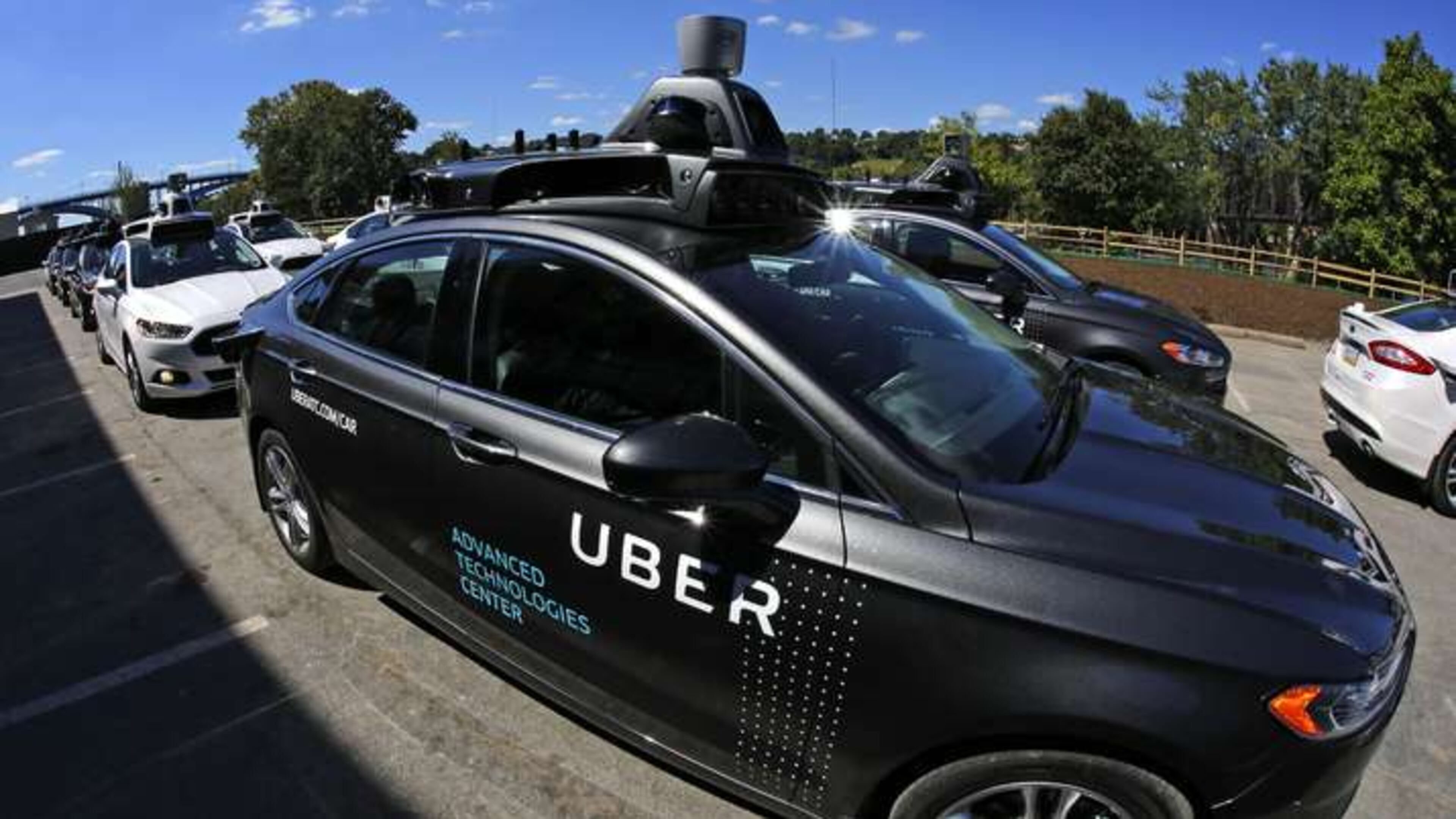 A group of self driving Uber vehicles position themselves to take journalists on rides during a media preview at Uber's Advanced Technologies Center in Pittsburgh Sept. 12, 2016. (AP Photo / Gene J. Puskar)
