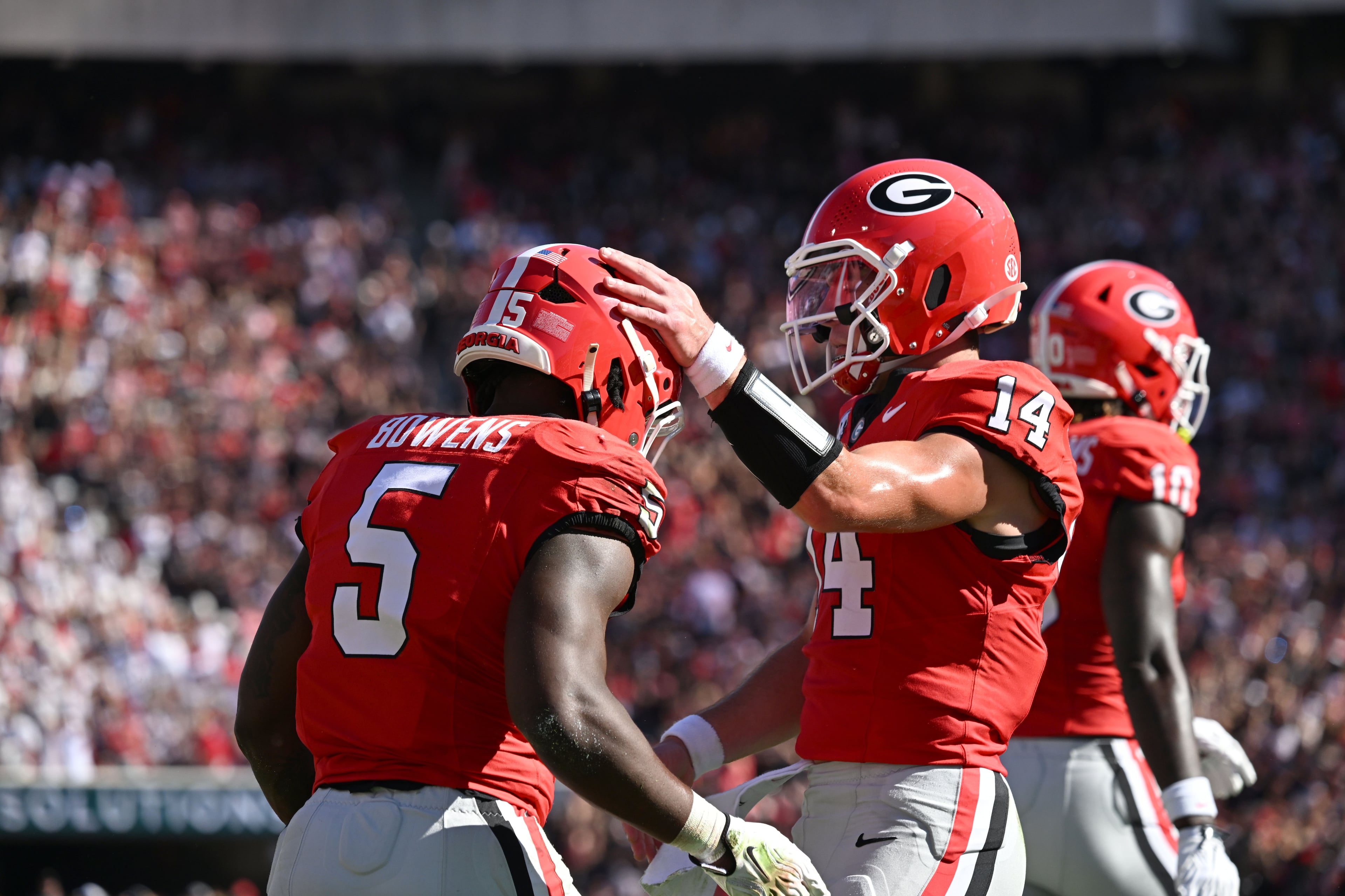 Georgia running back Chauncey Bowens (left) celebrates with Georgia quarterback Gunner Stockton (center) after scoring a touchdown during the first half of an NCAA football game at Sanford Stadium on Saturday, Sept. 26, 2026, in Athens, Ga. (Hyosub Shin/AJC)