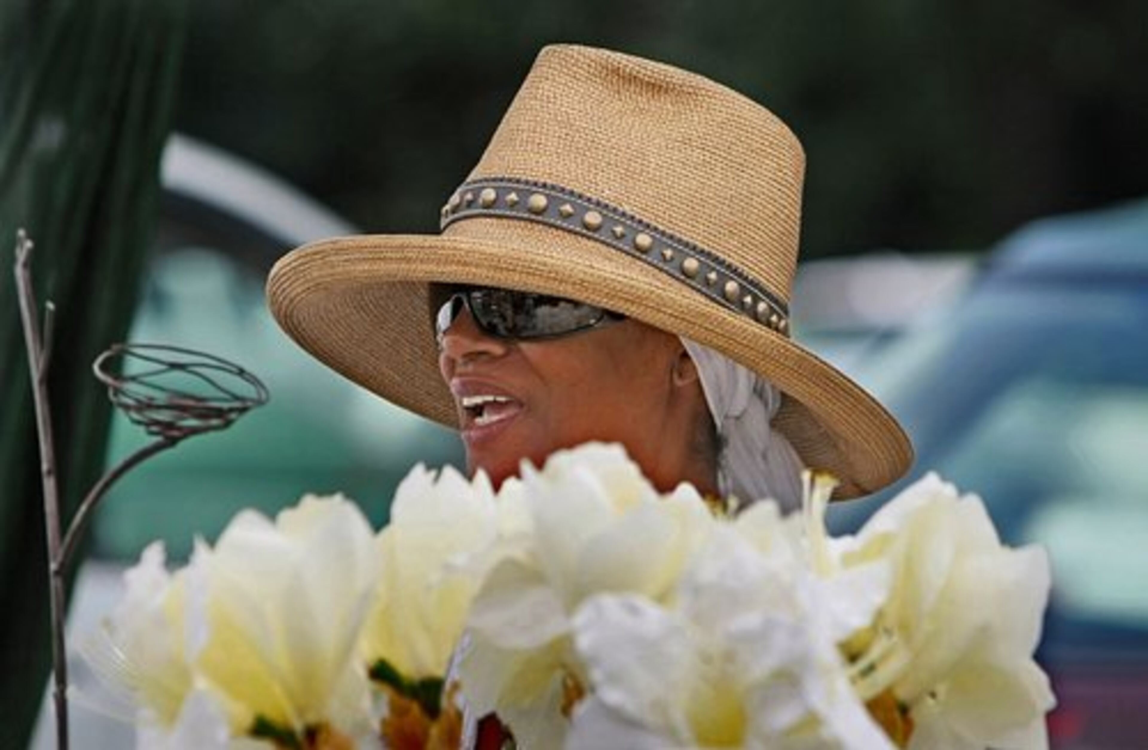 Visual artist Jan Is of Atlanta smiles at shoppers interested in her collection of jewelry.