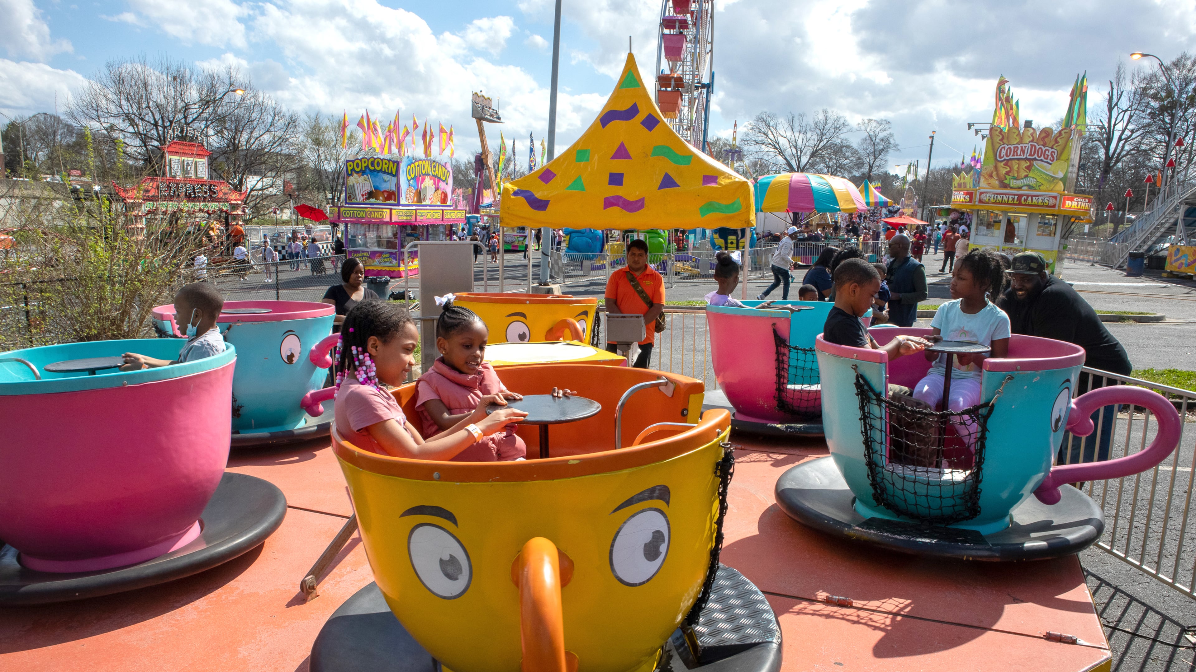 Kids ride in teacups at the Atlanta Fair on Sunday, March 6, 2022. This was the opening weekend for the annual fair that runs through April 10. (Photo by Steve Schaefer for The Atlanta Journal-Constitution)