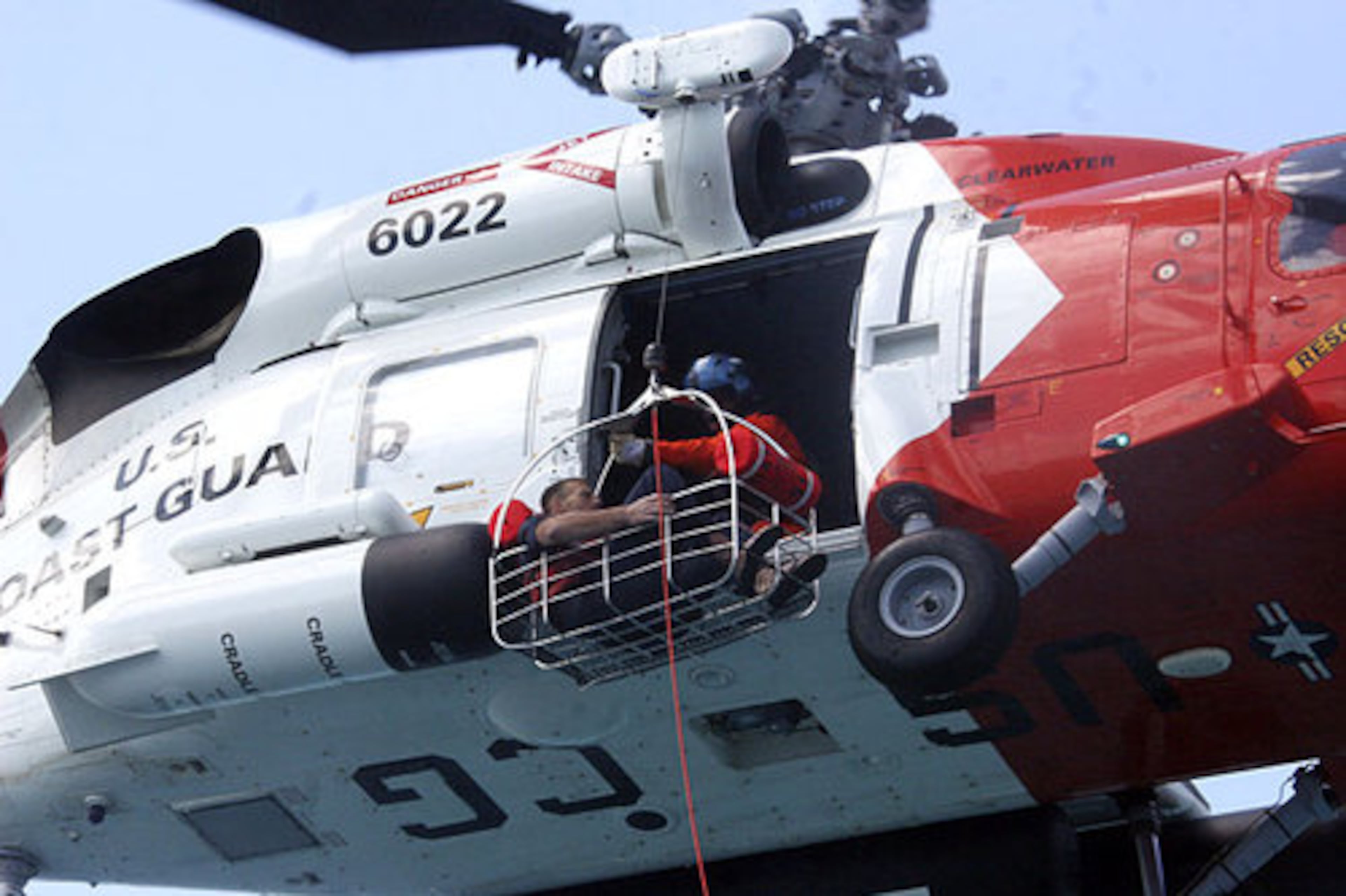 Schuyler is pulled up to a U.S. Coast Guard helicopter in a basket.