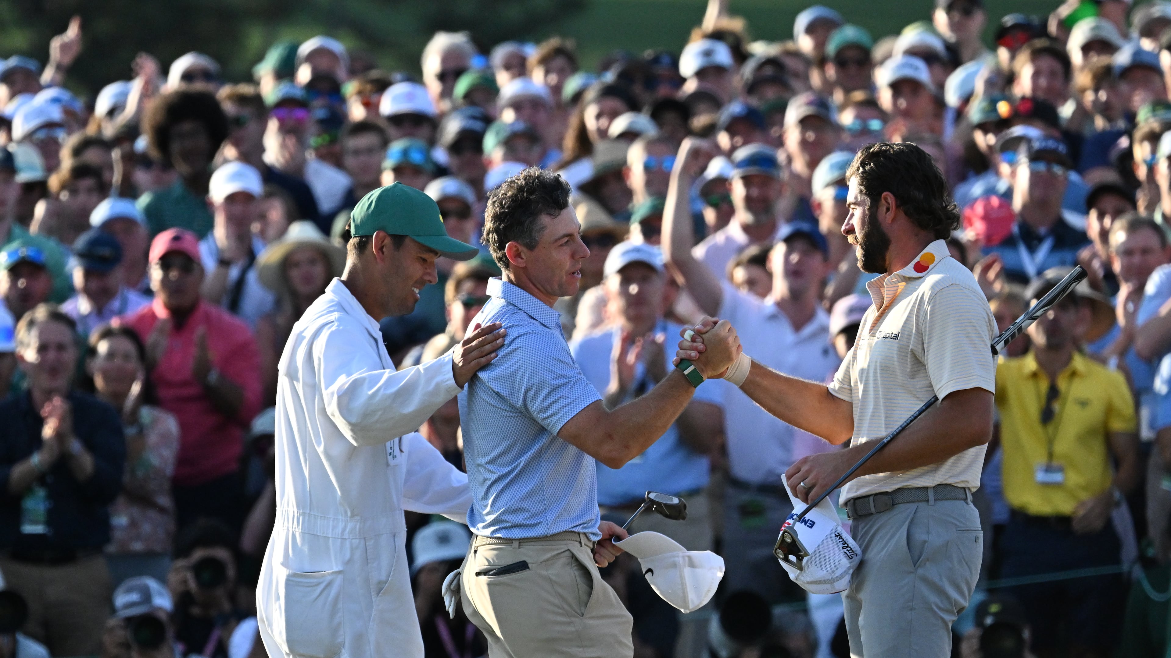 Rory McIlroy and caddie Harry Diamond greet Cameron Young at the end pf the final round of the Masters, at Augusta National Golf Club, Sunday, April 12, 2026, in Augusta, GA (Hyosub Shin/AJC)