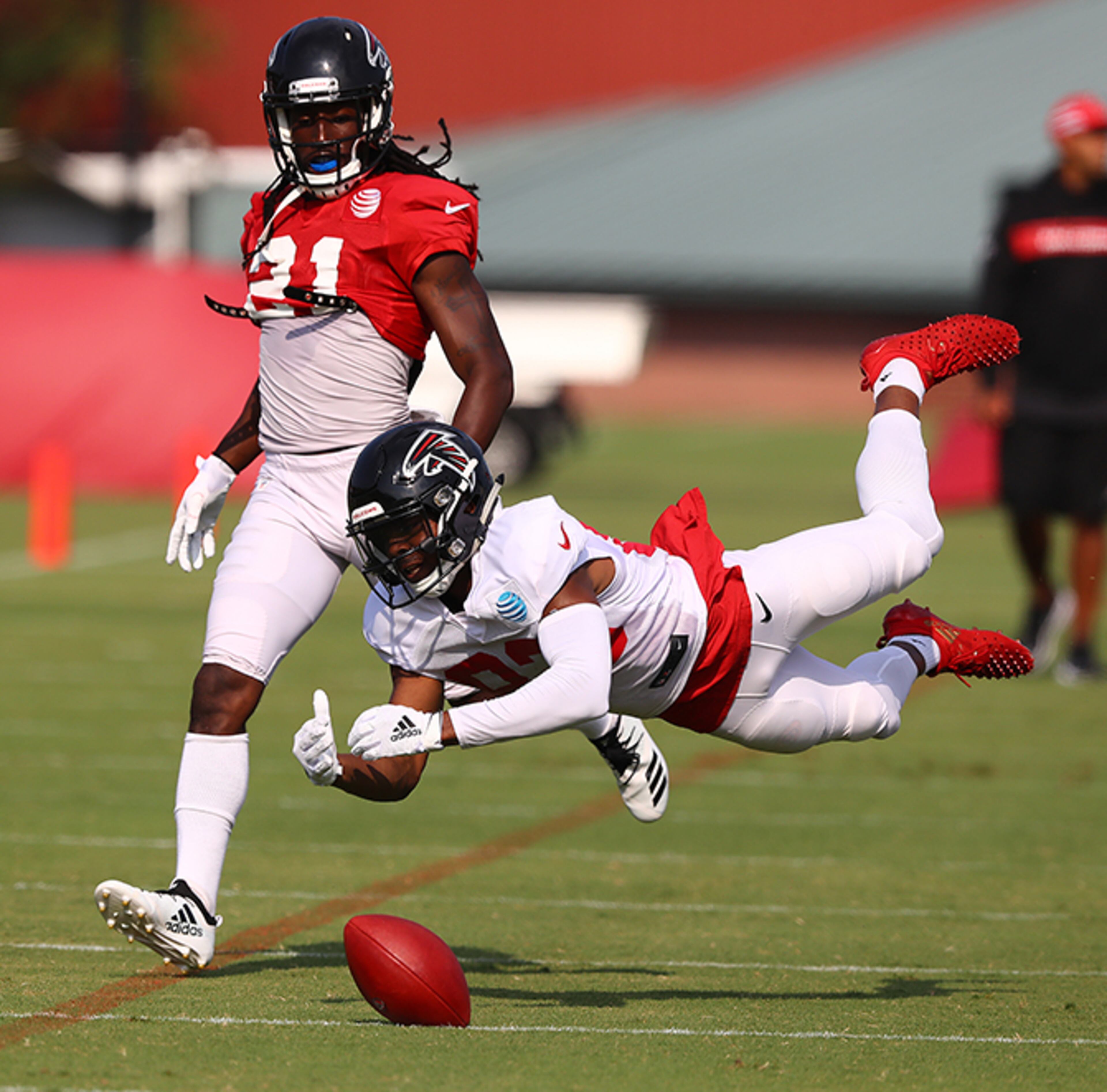Falcons wide receiver Russell Gage is open on a long route but can't haul in to the pass - while Desmond Trufant defends - during team scrimmage Monday, July 29, 2019, in Flowery Branch.