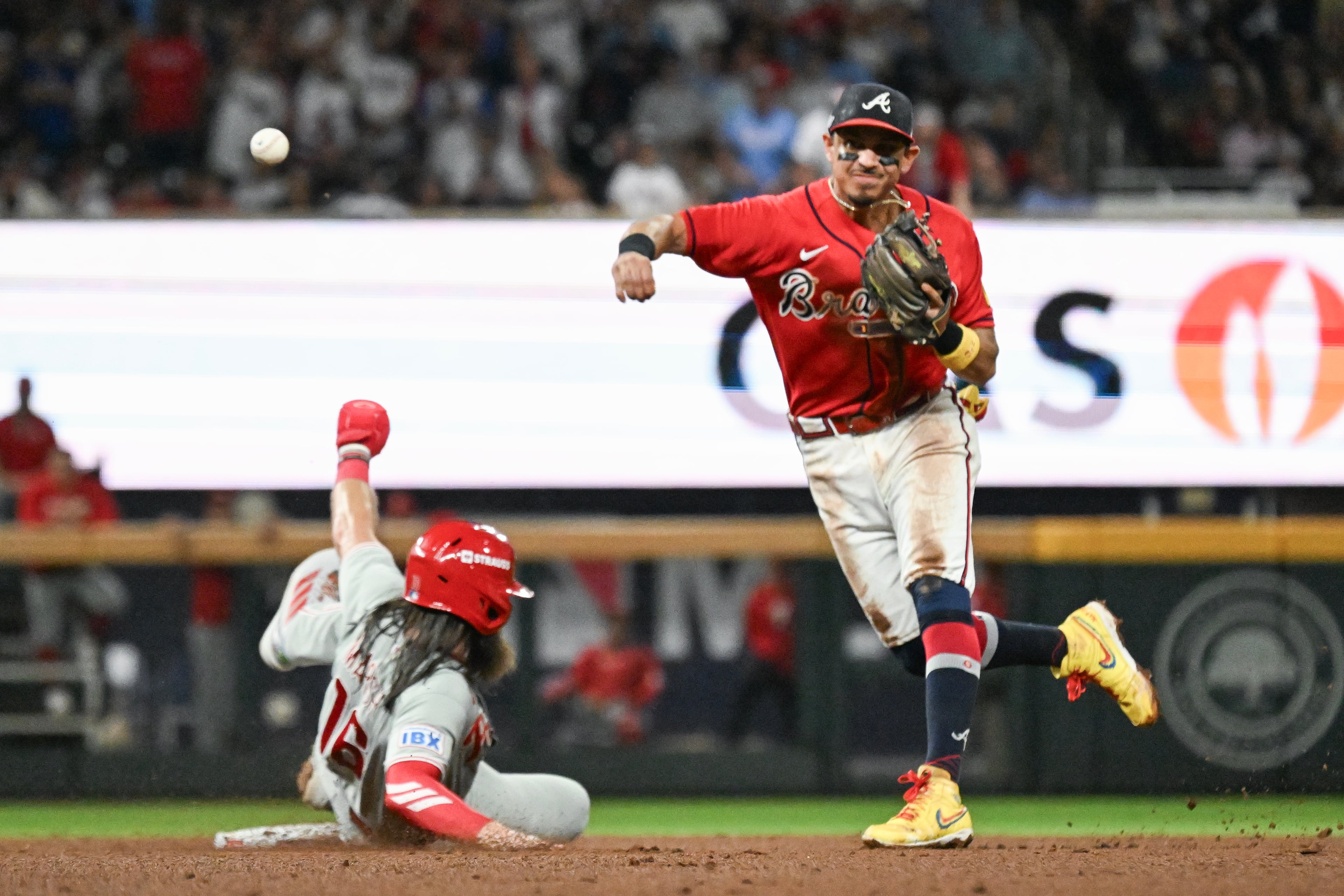Braves left fielder Mauricio Dubón (right) turns an inning-ending double play against Phillies left fielder Brandon Marsh during Game 3 of their NL Wild Card Series on Thursday, Oct. 1, 2026, at Truist Park in Atlanta. (Hyosub Shin/AJC)