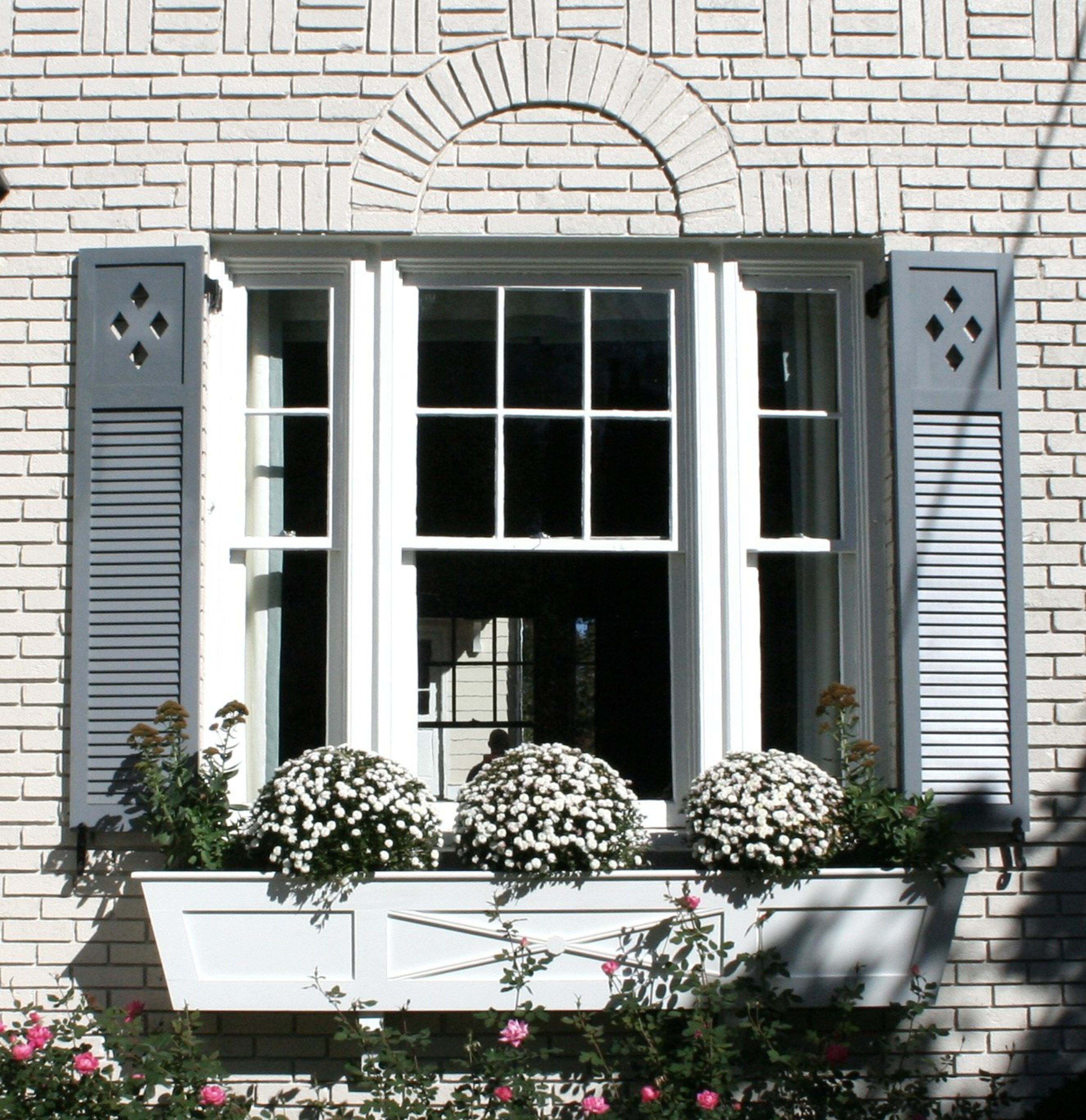 This homeowner wanted to add a "storybook" feature as part of the renovation to her 1920s colonial home in Brookwood Hills. The cutouts on the top panel of the shutter helped.