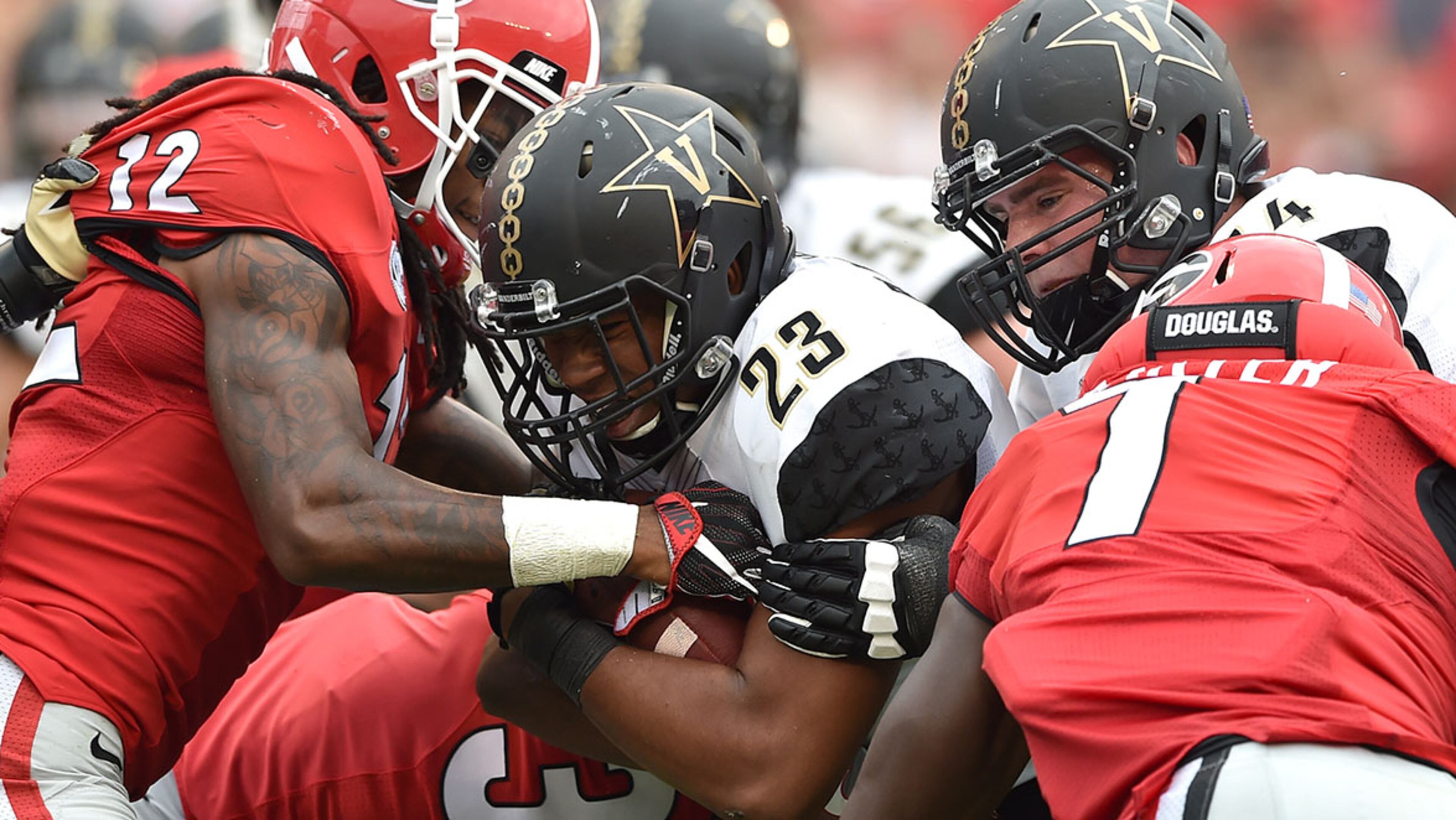Georgia Bulldogs defensive back Juwuan Briscoe tries to strip the ball from Vanderbilt Commodores running back Khari Blasingame during the 4th quarter on Saturday, Oct. 15, 2016, at Sanford Stadium in Athens.