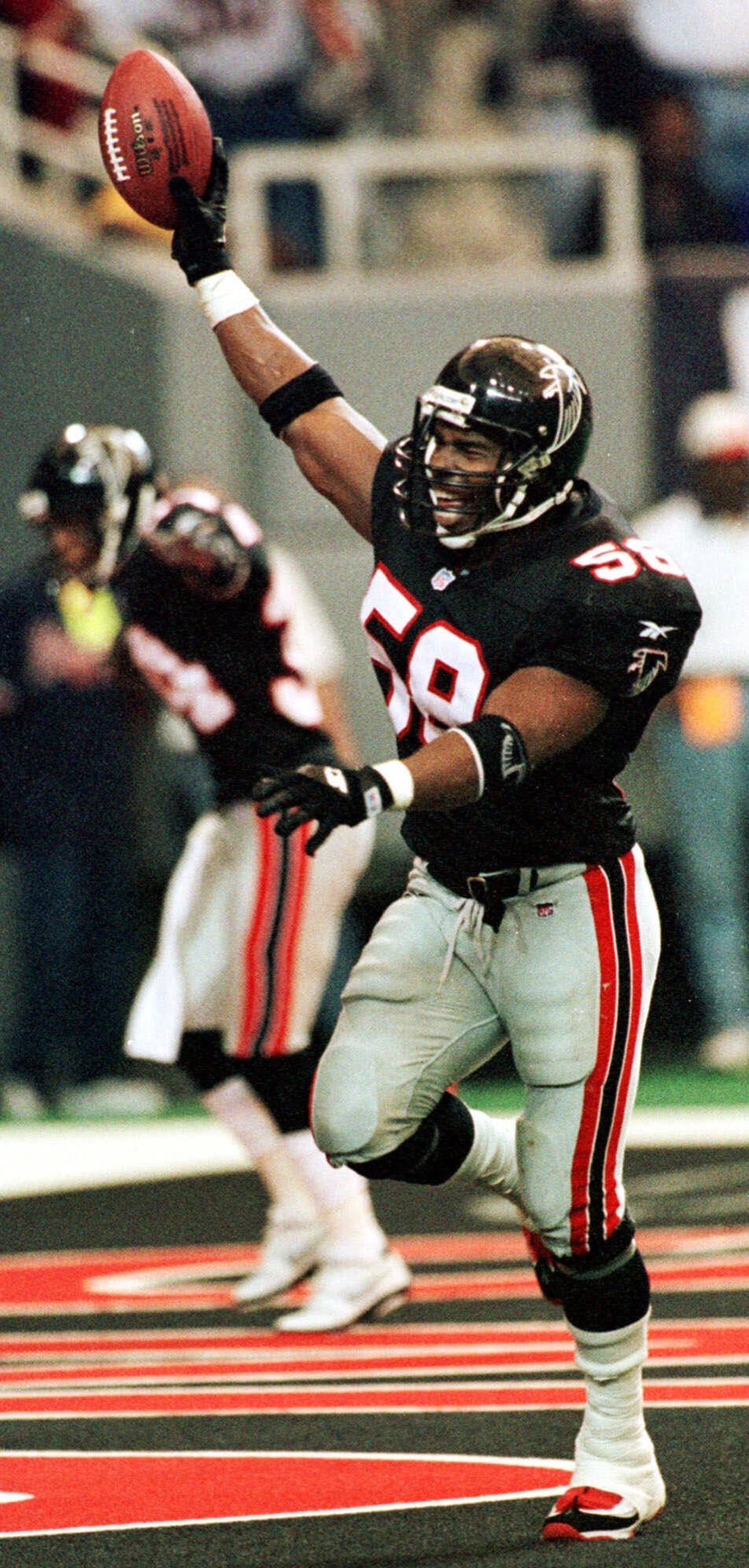 Jessie Tuggle (58) of the Falcons celebrates a touchdown he scored after a fumble by 49ers quarterback Steve Young fumble on Nov. 15, 1998. (AP Photo/John Bazemore)