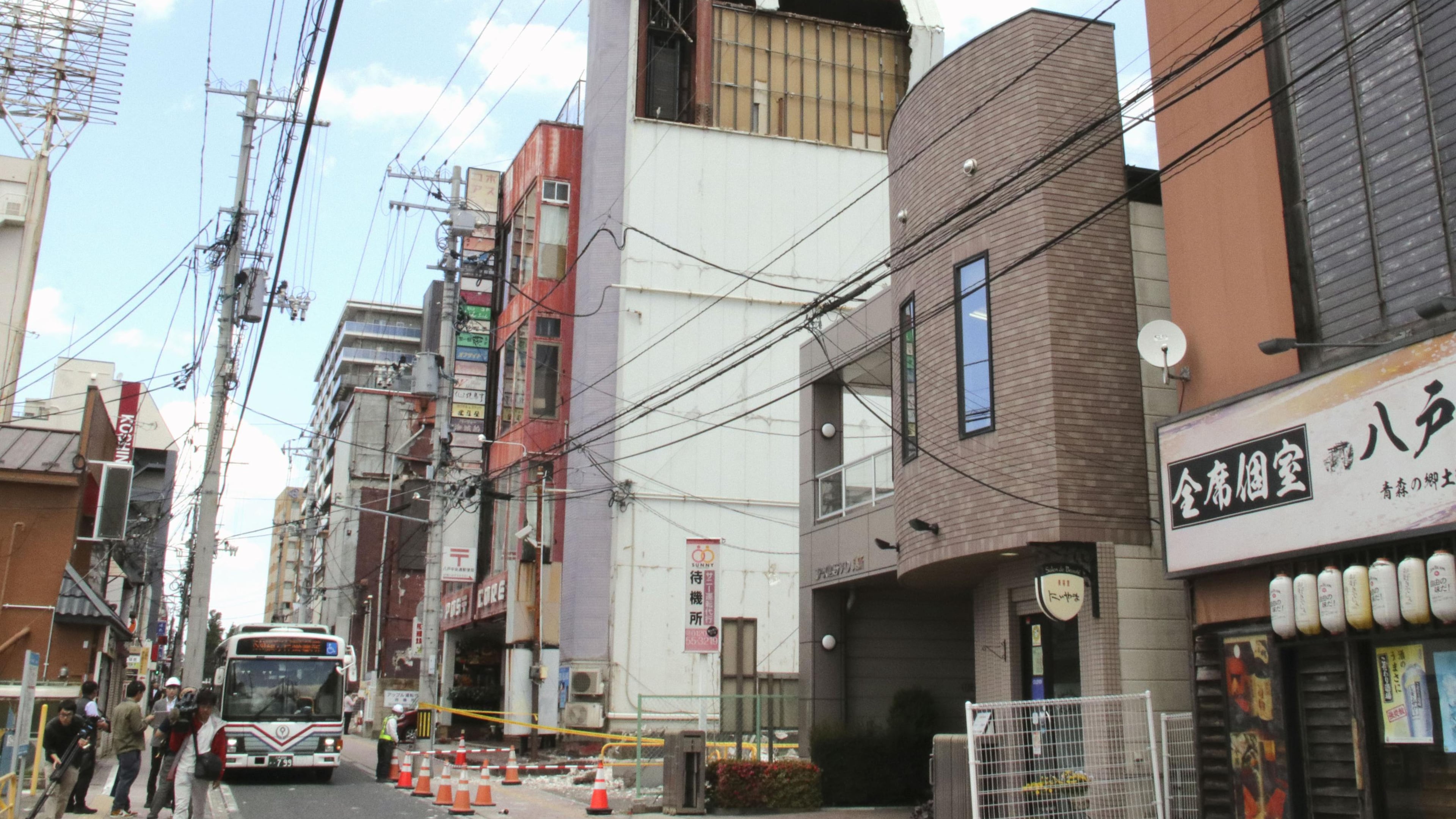 The wall of a building is seen partly damaged following an earthquake in Hachinohe, Aomori prefecture northern Japan, Thursday, June 25, 2026. (Kyodo News via AP)