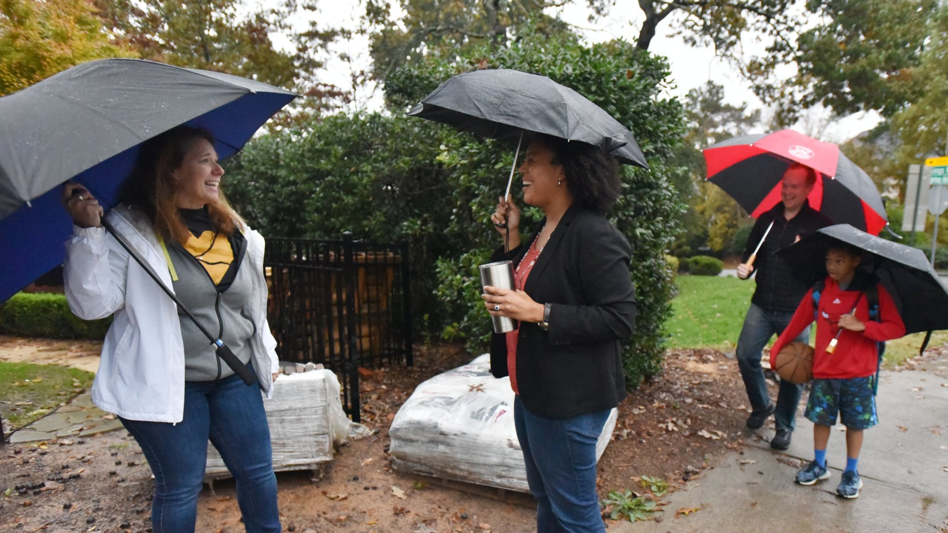 Charisse Davis, a newly elected school board member in Cobb County, talks with her supporter and neighbor Linda Trocano (left) as she and husband Sean Davis (background) walk their 9-year-old son Harrison to Teasley Elementary School in Smyrna on Friday, Nov. 9, 2018. The election brought increased diversity in the boards of the two largest school districts in the state. Gwinnett County has its first school board member of color and its second Democrat. Cobb County has added two blacks a woman to the all-male board that had one minority member before. HYOSUB SHIN / HSHIN@AJC.COM