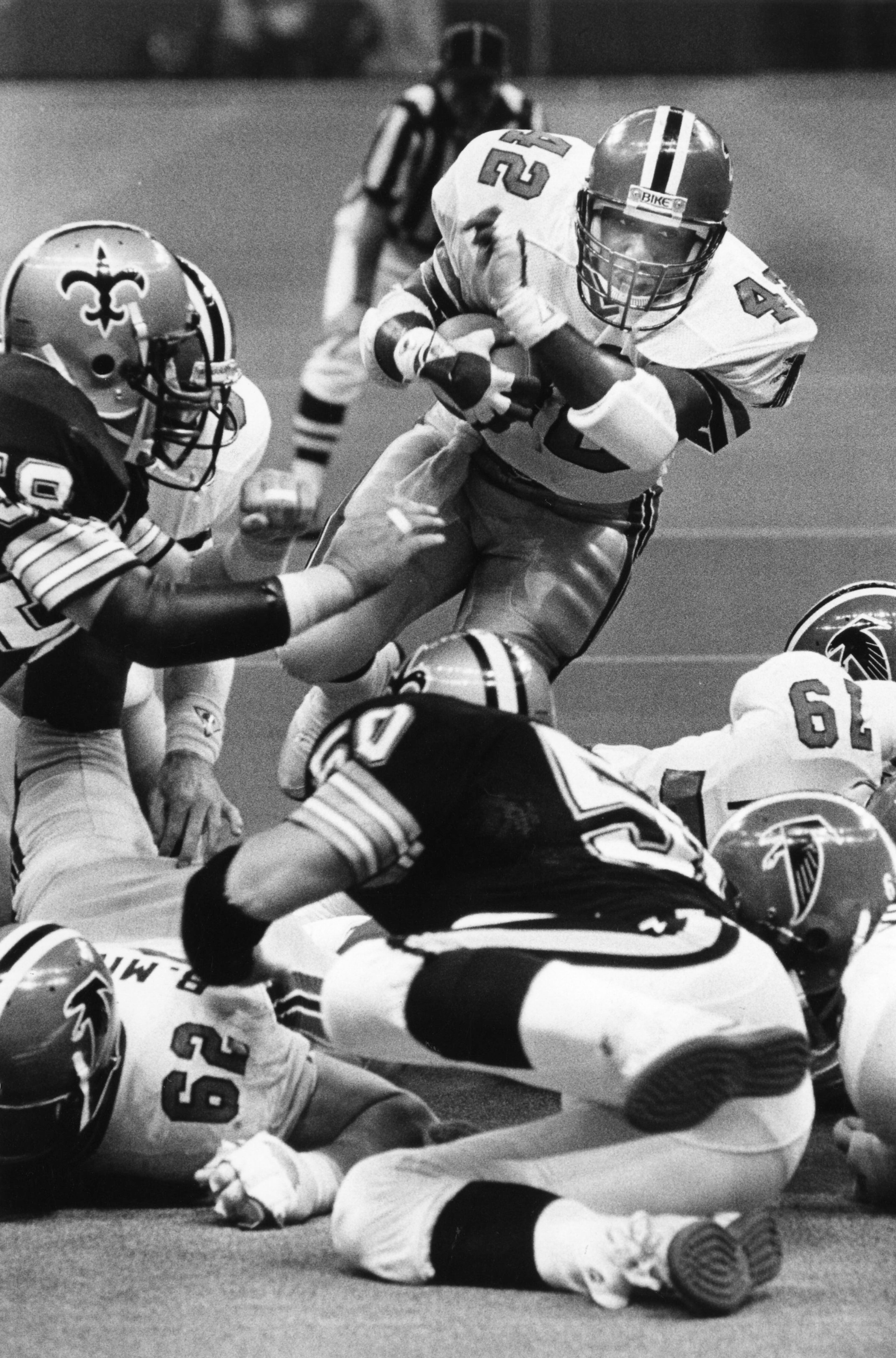Riggs dives over some Saints to score a touchdown in 1985. Kenneth Walker / AJC