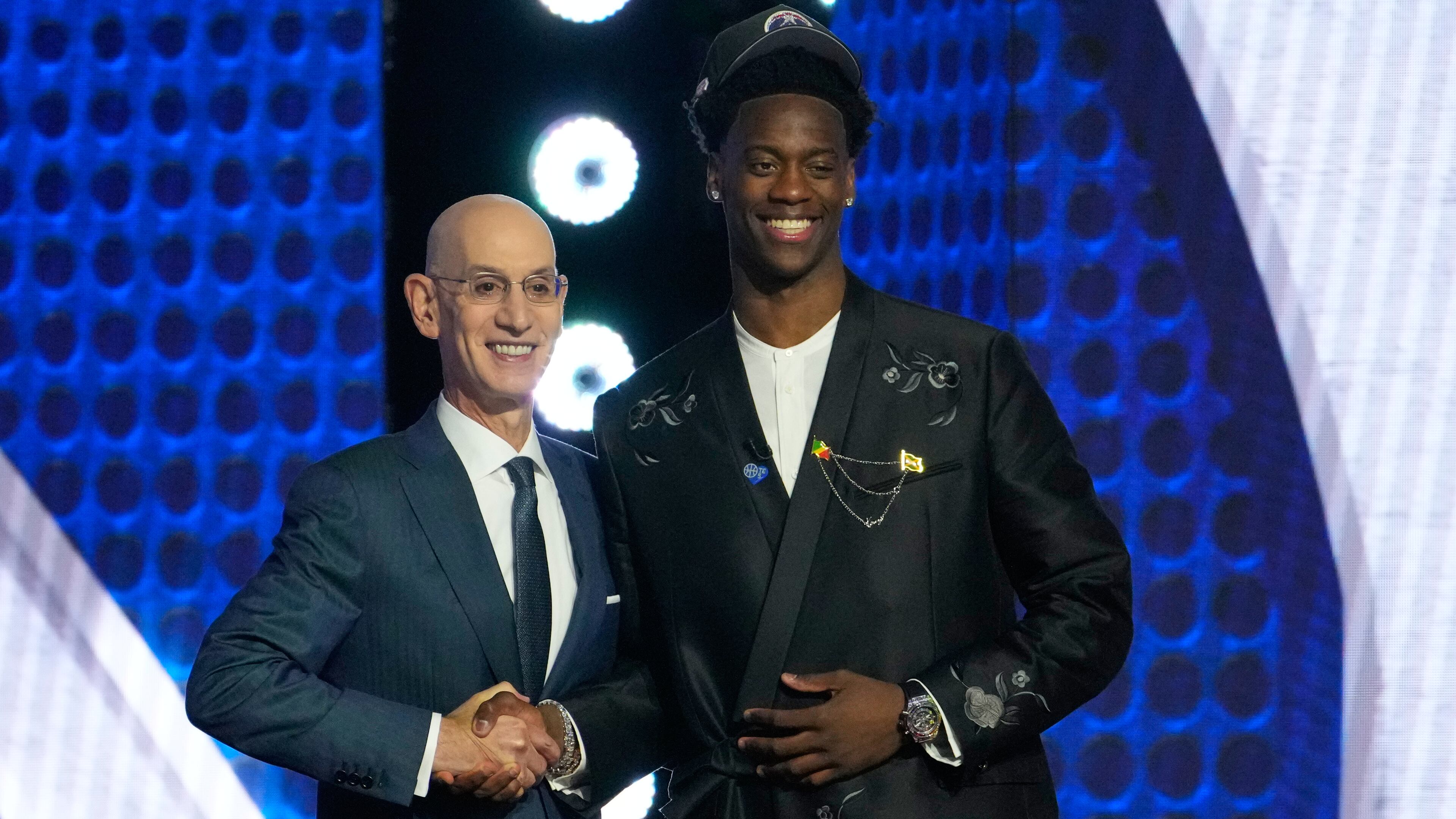AJ Dybantsa, right, poses for a photo with NBA commissioner Adam Silver, left, after being selected by the Washington Wizards as the first pick in the first round of the NBA basketball draft, Tuesday, June 23, 2026, in New York. (AP Photo/Yuki Iwamura)