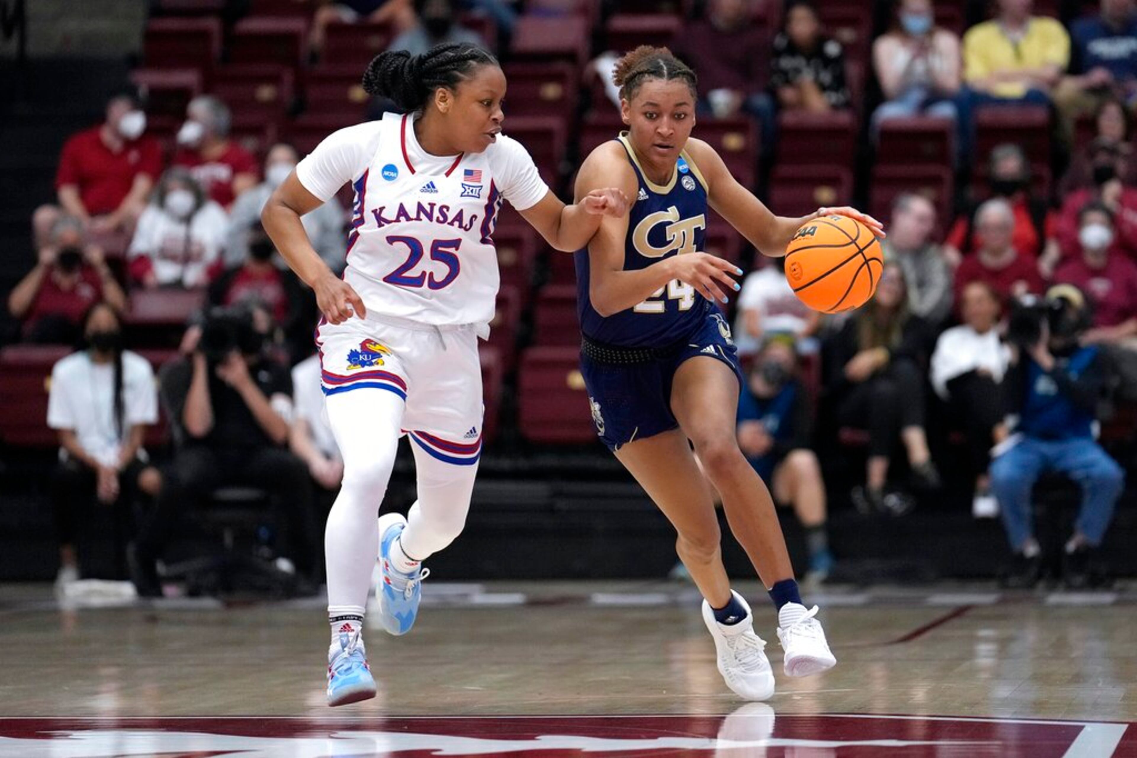 Georgia Tech guard Eylia Love (24) brings the ball up as Kansas guard Chandler Prater (25) defends during the first half of a first-round game in the NCAA women's college basketball tournament Friday, March 18, 2022, in Stanford, Calif. (AP Photo/Tony Avelar)