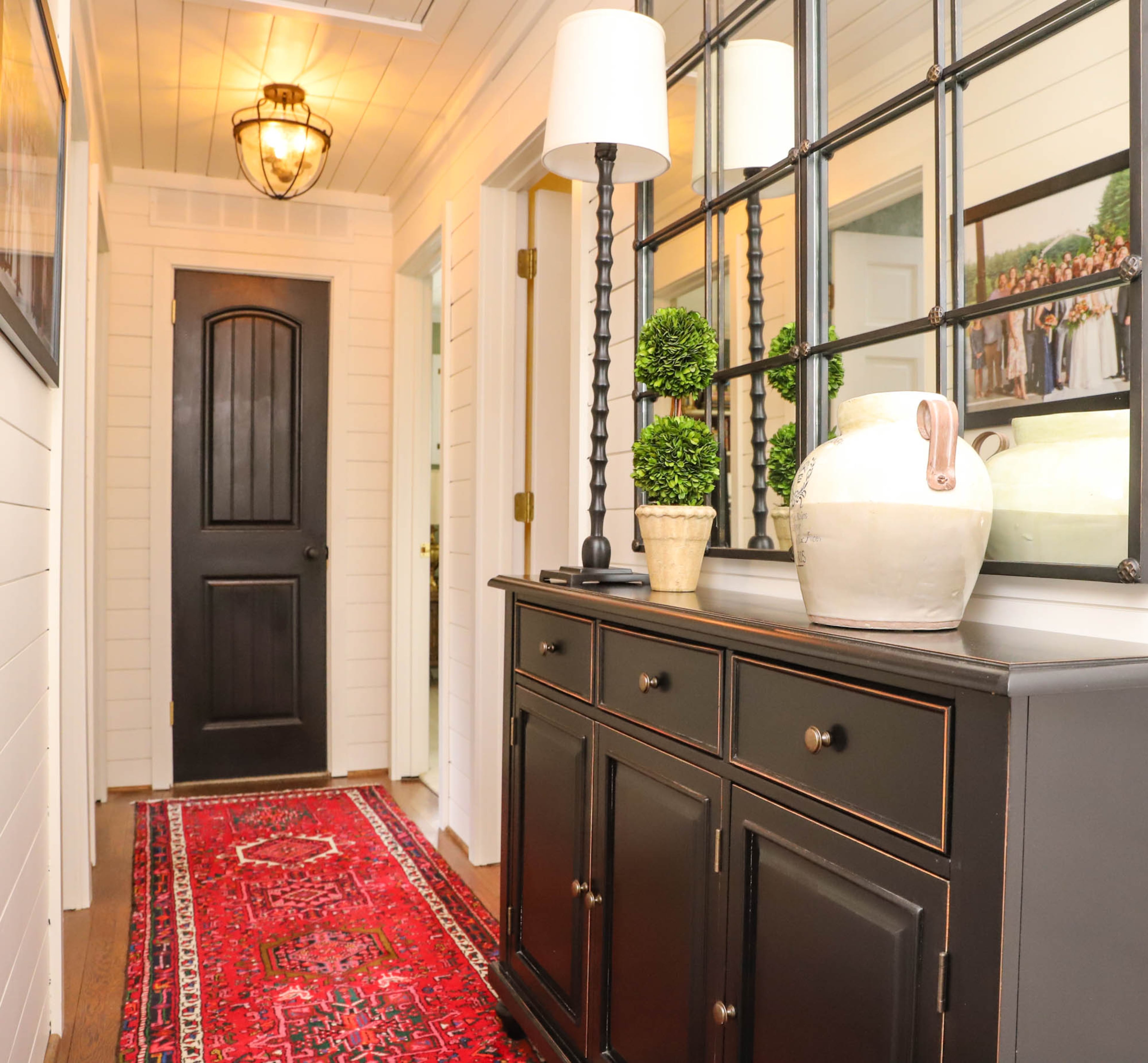 Last year Jane Carlton decided she wanted shiplap in her Fulton County home’s hallway, so her husband, Leo Carlton, who spent his career as a contractor, got right to it, giving the hall of their traditional home a more mid century modern vibe. They finished the look with an oriental rug runner and a sideboard and mirror, both from Ballard Designs. Text by Shannon Dominy/Photo by Reynolds Rogers