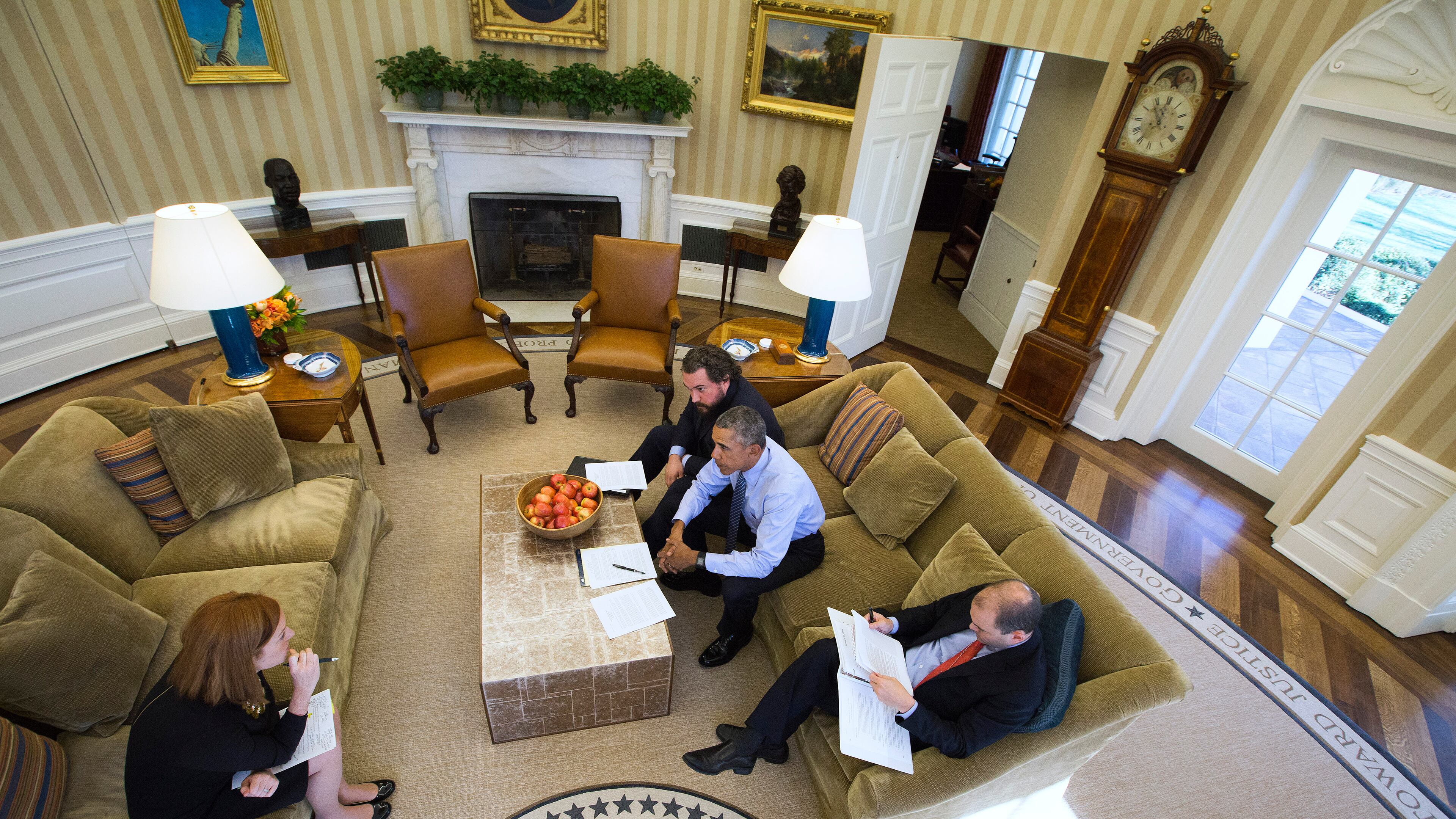 President Barack Obama works with Cody Keenan, rear, the president’s director of speechwriting, Ben Rhodes, the deputy national security adviser, and Jen Psaki, left, Director of White House Communications, in the Oval Office of the White House on the eve of his final State of the Union in Washington, Jan. 11, 2016. (Doug Mills/The New York Times)
