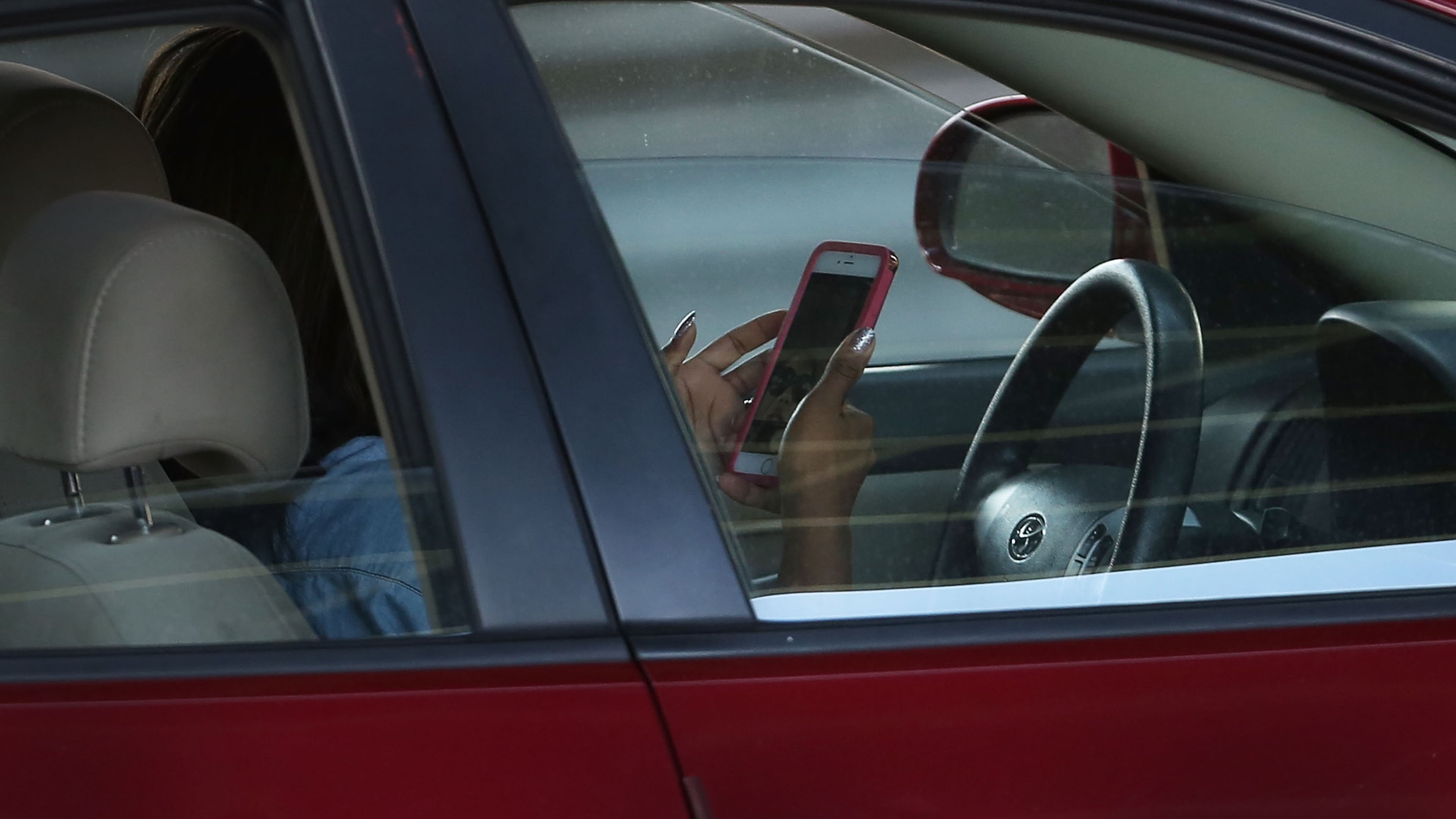 FILE PHOTO: A new study suggests that many drivers think that it is safe to use their cell phones while driving.