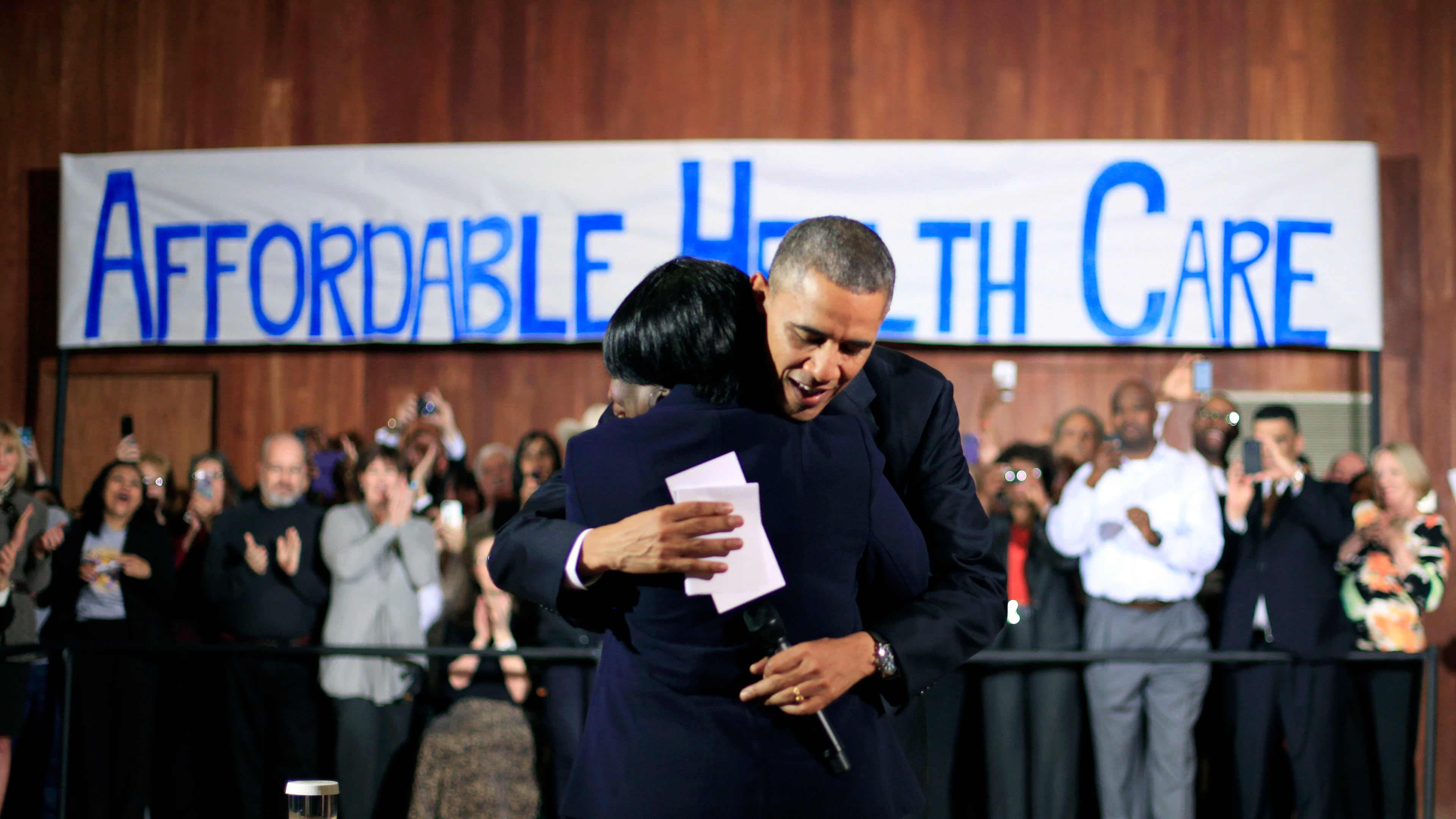 President Barack Obama hugs Edna Pemberton, who introduced him, before speaking with volunteers who helped people enroll through the HealthCare.gov site at Temple Emanu-El Wednesday, Nov. 6, 2013, in Dallas. Obama traveled to Texas to pitch health care and raise money for the Democratic party. (AP Photo/Pablo Martinez Monsivais)