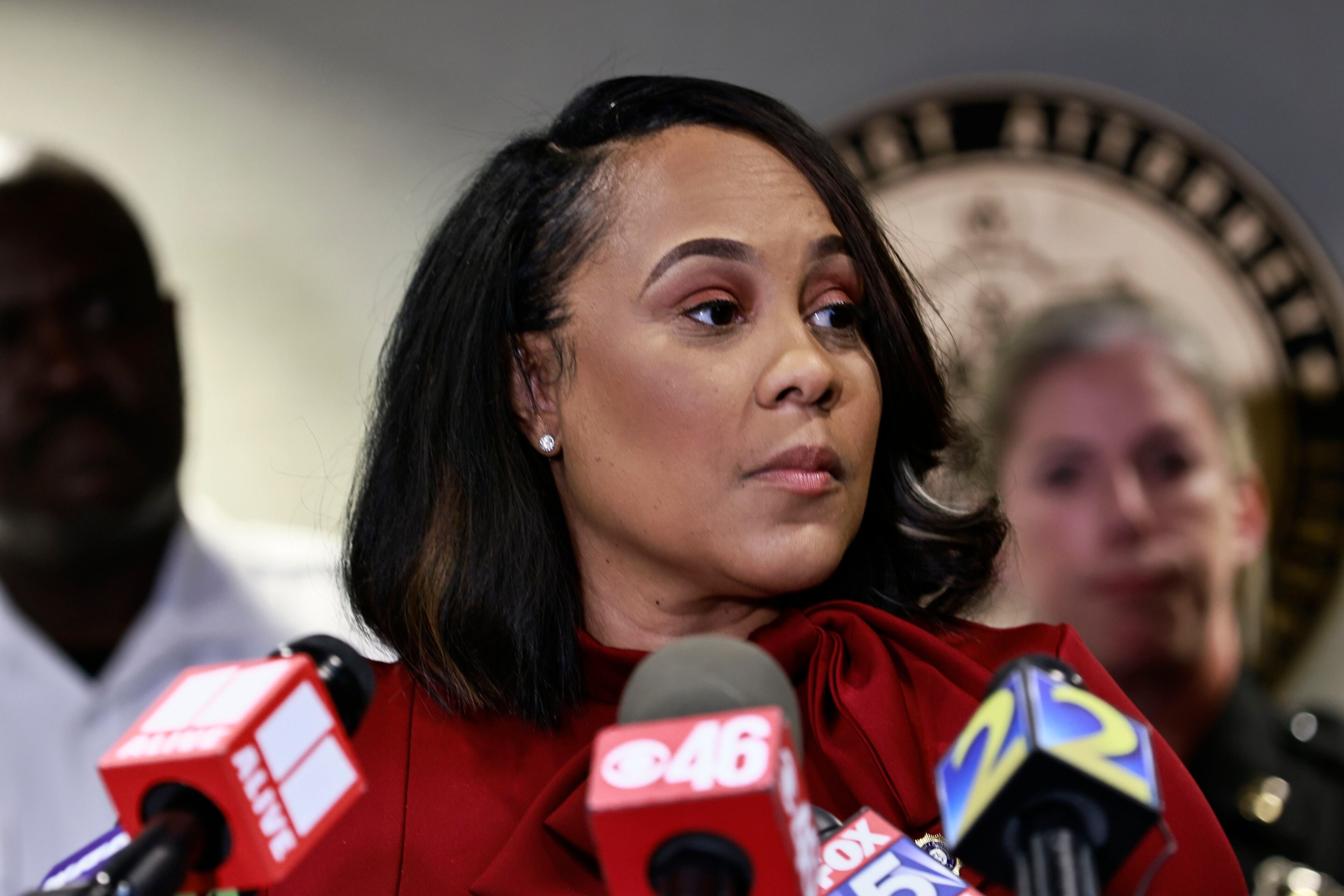 In this photo from Aug. 29, 2022, surrounded by Fulton County law enforcement officials, District Attorney Fani Willis speaks during a news conference about the RICO indictment in the celebrity home invasion ring. (Natrice Miller/The Atlanta Journal-Constitution/TNS)