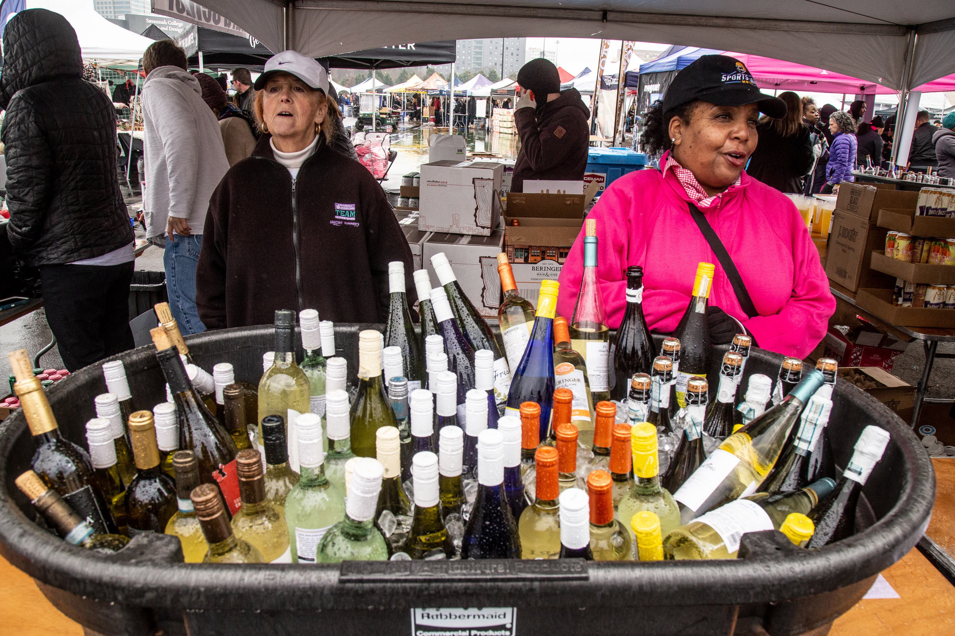 Cookie Farrell (L) and Dorothy Lee wait for customers to hand out their wine samples during the Atlanta Winter Beer Festival at Atlantic Station on Saturday, February 1, 2020. STEVE SCHAEFER / SPECIAL TO THE AJC