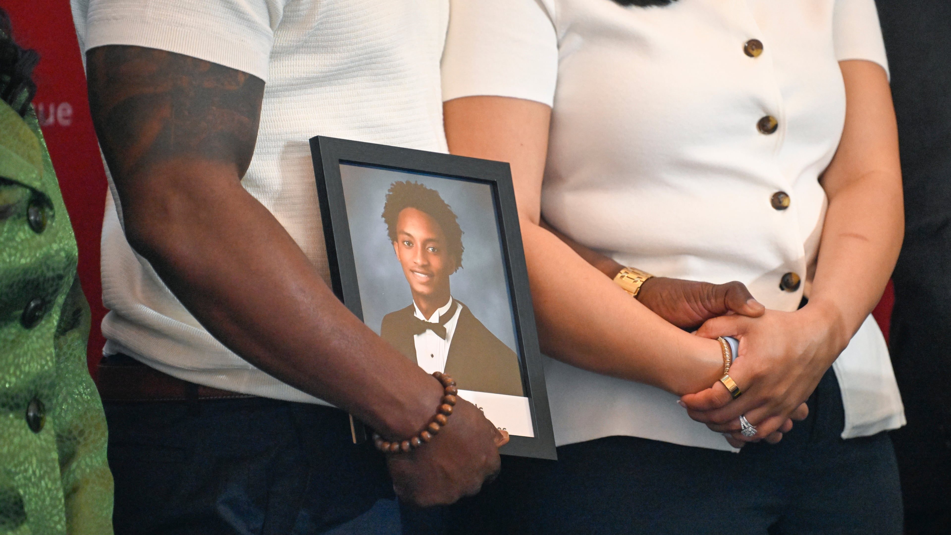 Christine Wonsley and Elmore Wonsley, mother and step father of Nolan Wells, stand on a stage with a photo of their son as they appear at the National Urban League's annual conference to share updates on his death, as well as Daniel Erving, and Tyler Smith, Thursday, July 30, 2026, in Nashville, Tenn. (AP Photo/John Amis)