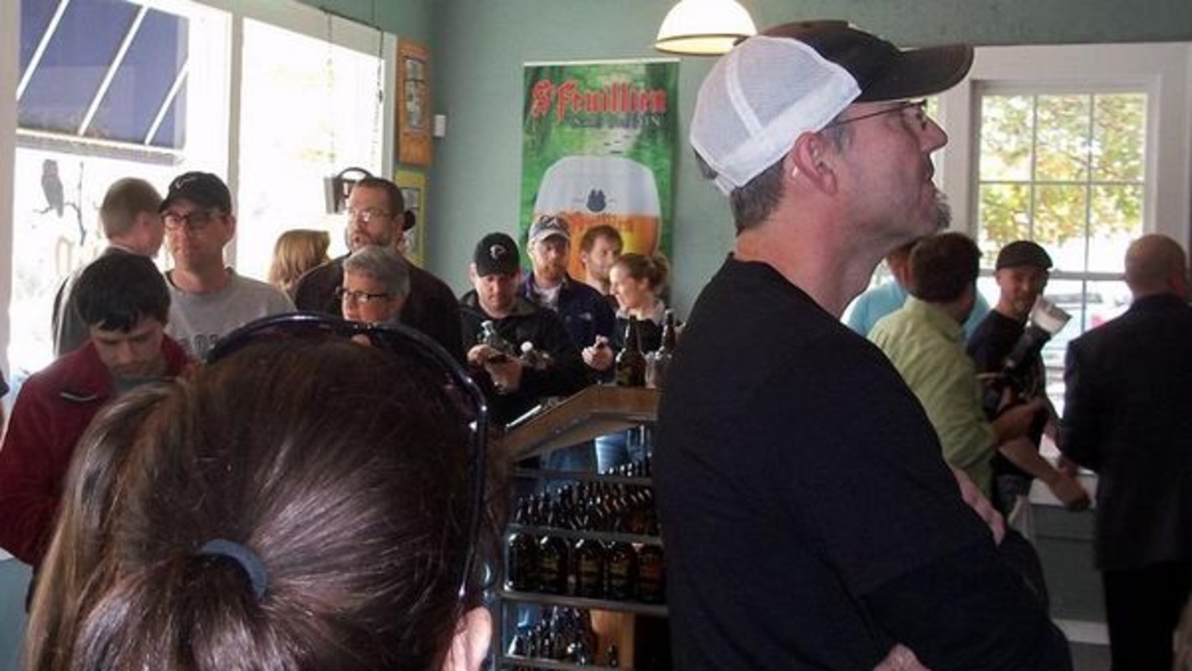 Customers line up to buy a growler at The Beer Growler in Avondale Estates in November 2011. Kristi Swartz/AJC