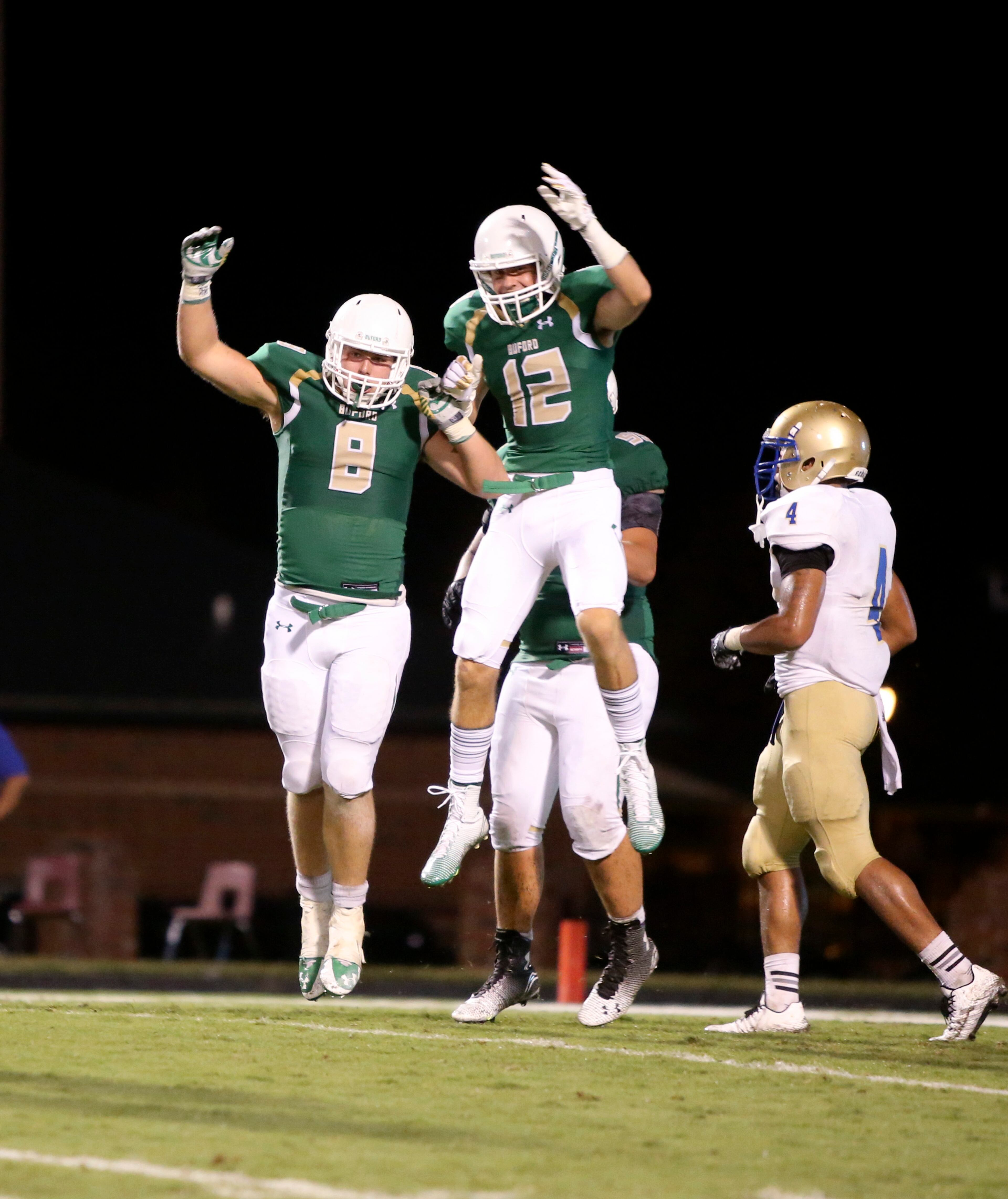 Buford tight end Caleb Auer (8) celebrates his two-point conversation with wide receiver Aaron Auer (12) in the second half of their game against McEachern Friday in Buford, Ga., Sept. 5, 2014. Buford would win 27-20. JASON GETZ / SPECIAL