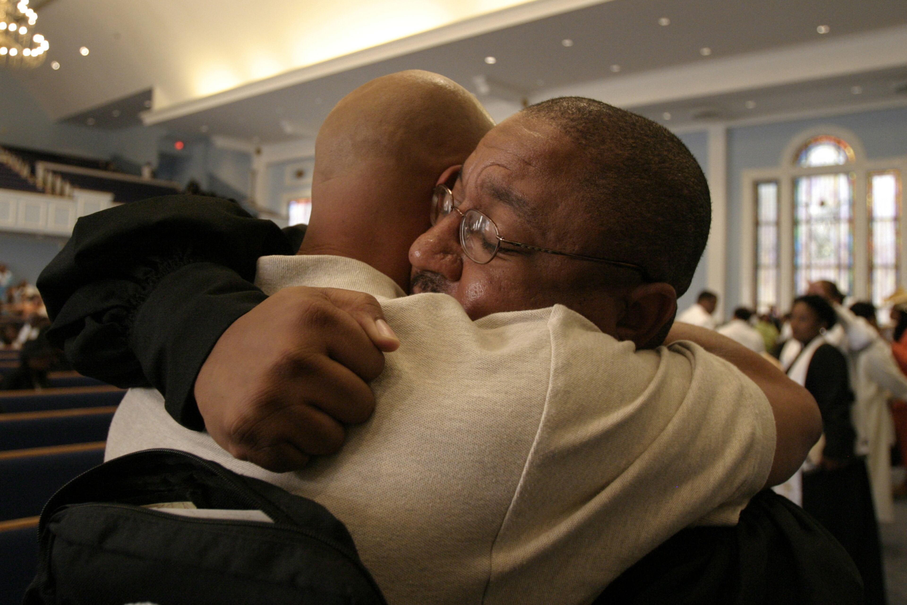 050904 - NORCROSS, GA -- Minister Johnny DiBartolo (cq, right) embraces Louisiana resident Timothy Jones (cq) after morning service at Hopewell Baptist church on Sunday, September 4, 2005. Jones evacuated New Orleans with twelve family members, including his 88 year-old grandfather. "Today's service was no different from any other Sunday. We just have an extended family present," DiBartolo said. (Mikki K. Harris/AJC staff)