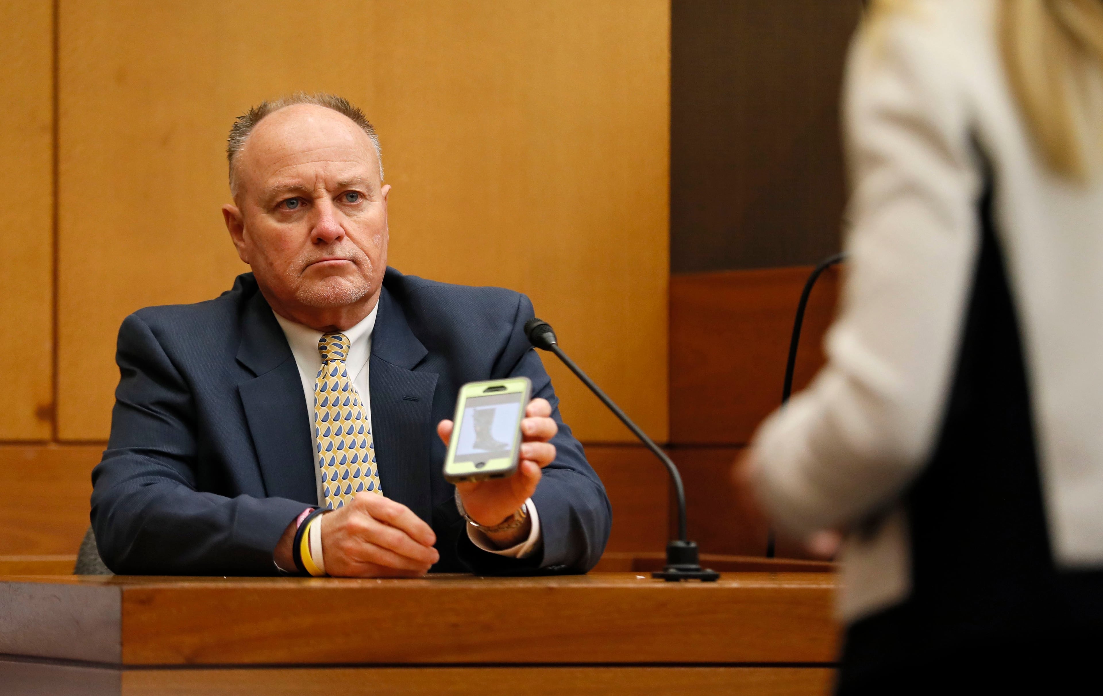 4/16/18 - Atlanta - Jay Grover, who worked for Diane McIver at U.S. Enterprises, shows a photo of rain boots similar to what he bought for her to Defense attorney Amanda Clark Palmer during the Tex McIver murder trial at the Fulton County Courthouse on Thursday, April 12, 2018. Bob Andres bandres@ajc.com