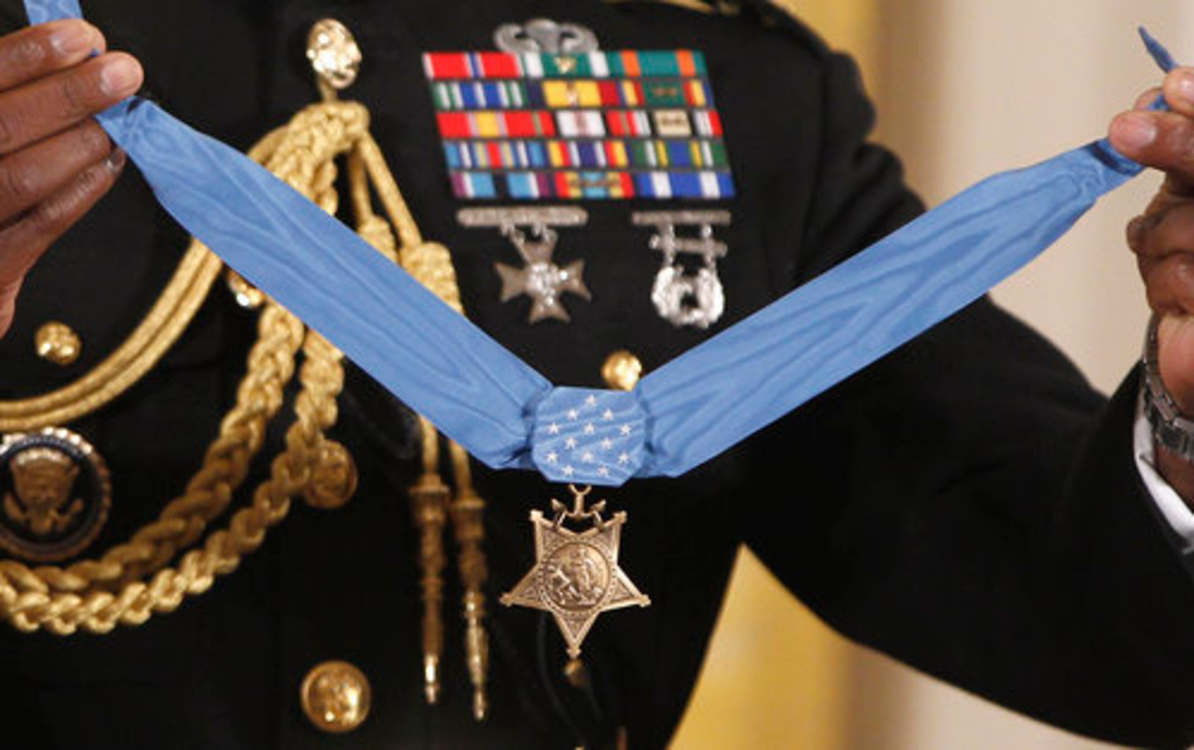 The Medal of Honor is held by a military honor guard .