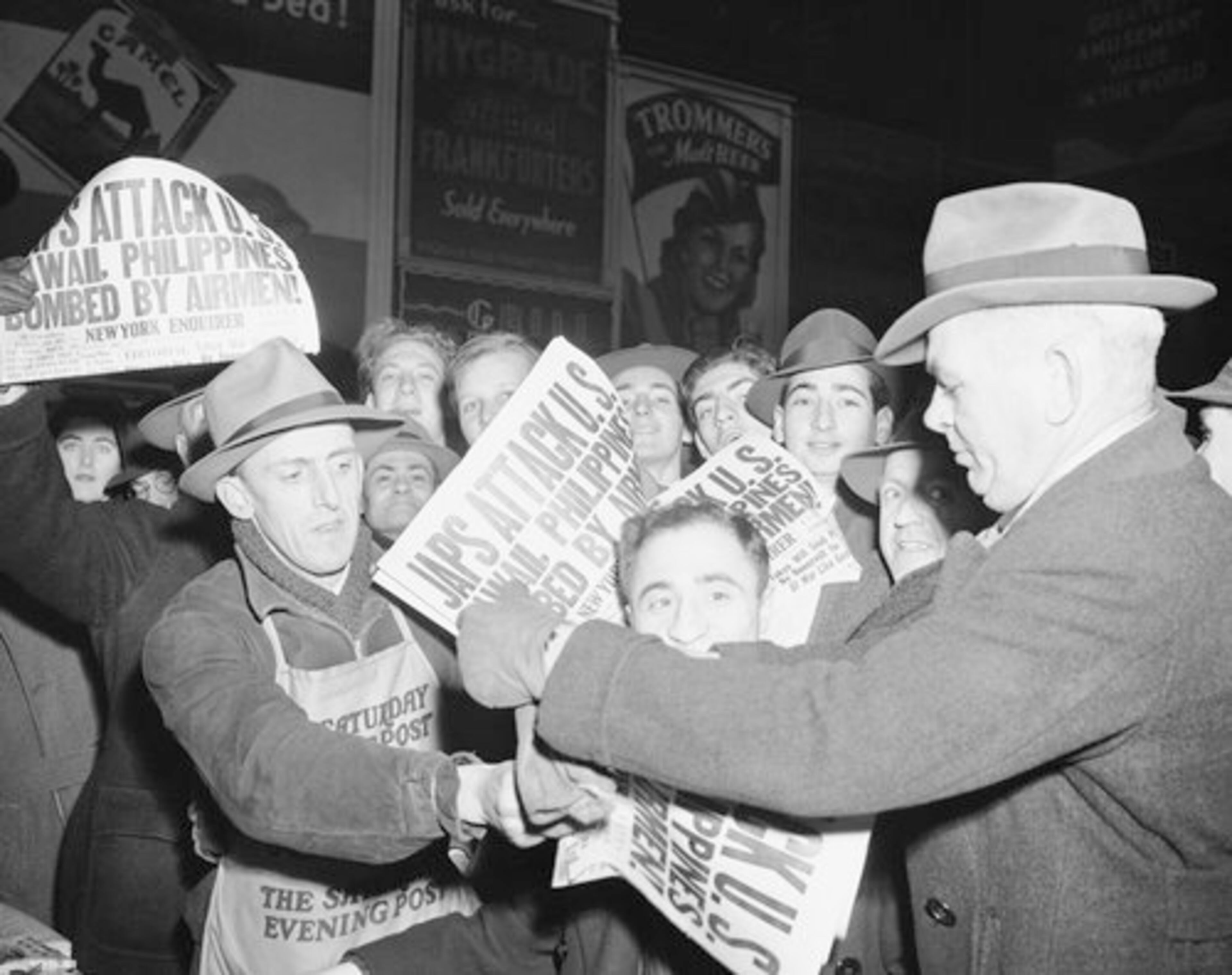 Selling papers on Dec. 7, 1941 at Times Square in New York City, announcing that Japan has attacked U.S. bases in the Pacific.