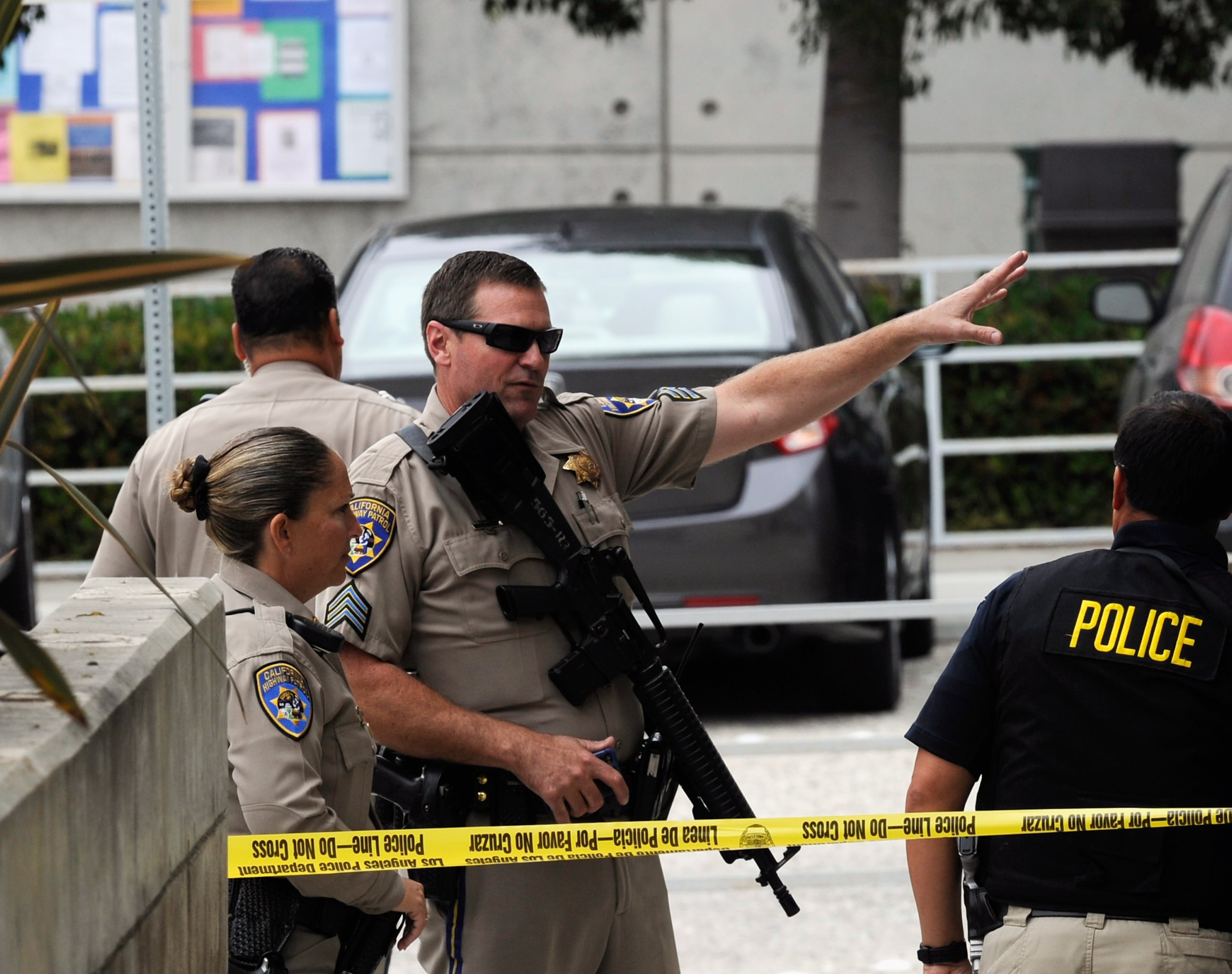 SANTA MONICA, CA - JUNE 07: California Highway Patrol Officers contain a scene at Santa Monica College after multiple shootings were reported on the campus June 7, 2013 in Santa Monica, California. According to reports, at least one person has died, four people hospitalized, and a suspect was taken into custody. (Photo by Kevork Djansezian/Getty Images)