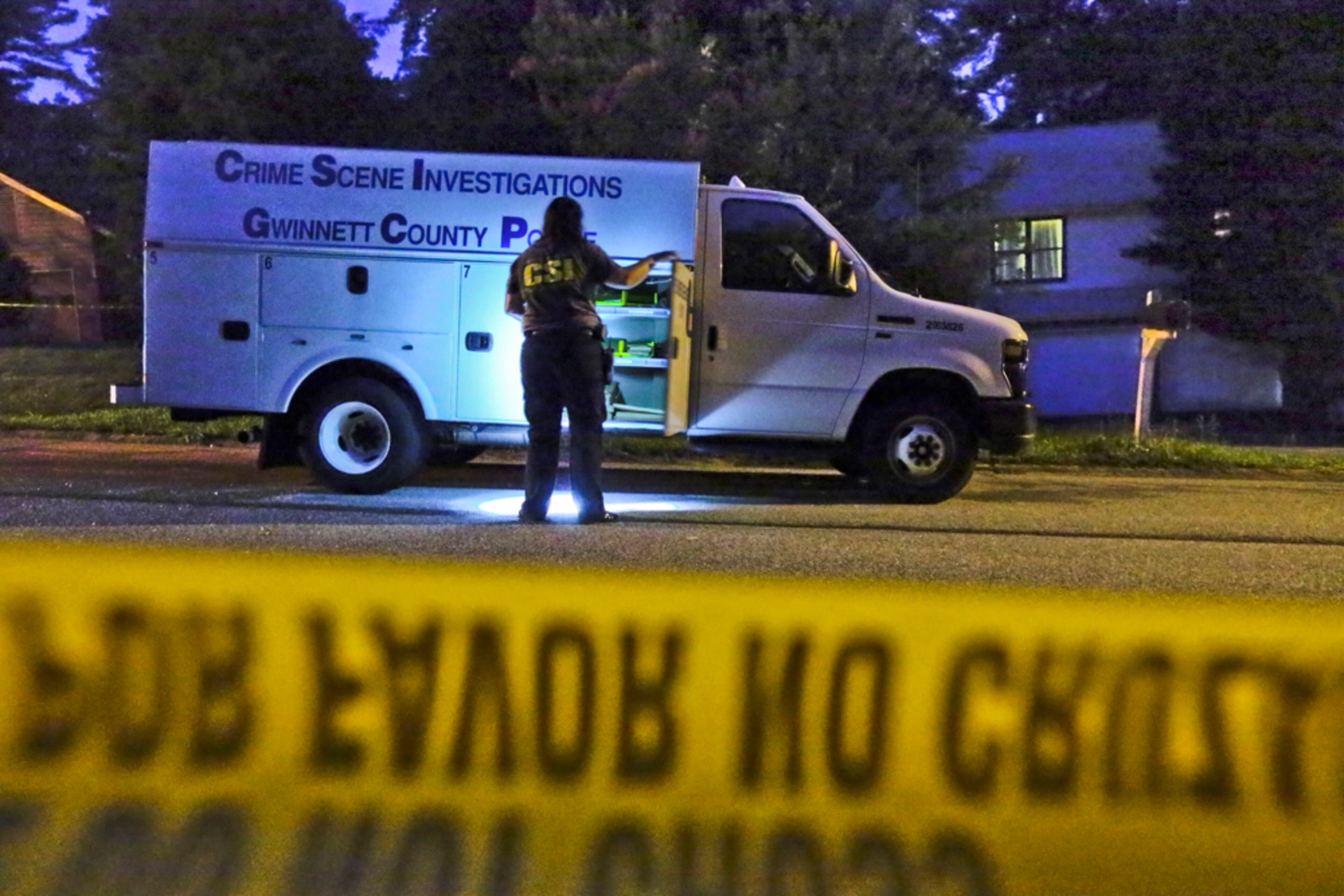 August, 9, 2013 Gwinnett County: Gwinnett County police crime scene specialist, B. Barrington gathers equipment at the crime scene Friday. Two women were taken in custody and police were still looking for three male suspects early Friday, Aug. 9, 2013 after a Gwinnett County man was shot during a home invasion robbery. The incident happened about 2:30 a.m. Friday at a home on Worchester Place near Lilburn, where the three male victims were roommates, Gwinnett police Cpl. Jake Smith said. “What we think happened is one of these guys met these ladies out somewhere socially at a bar or restaurant and invited them back to the house,” Smith said. “When they showed up, they brought a whole crew with them, and it turned into a robbery.” A BMW was stolen from one of the victims. “A very short time later, DeKalb County police stopped that BMW,” Smith said. “It was occupied by two women matching the description of the suspects.” The women were turned over to Gwinnett police. “We don’t have the three men in custody, but we do have the two women,” Smith said. JOHN SPINK/JSPINK@AJC.COM