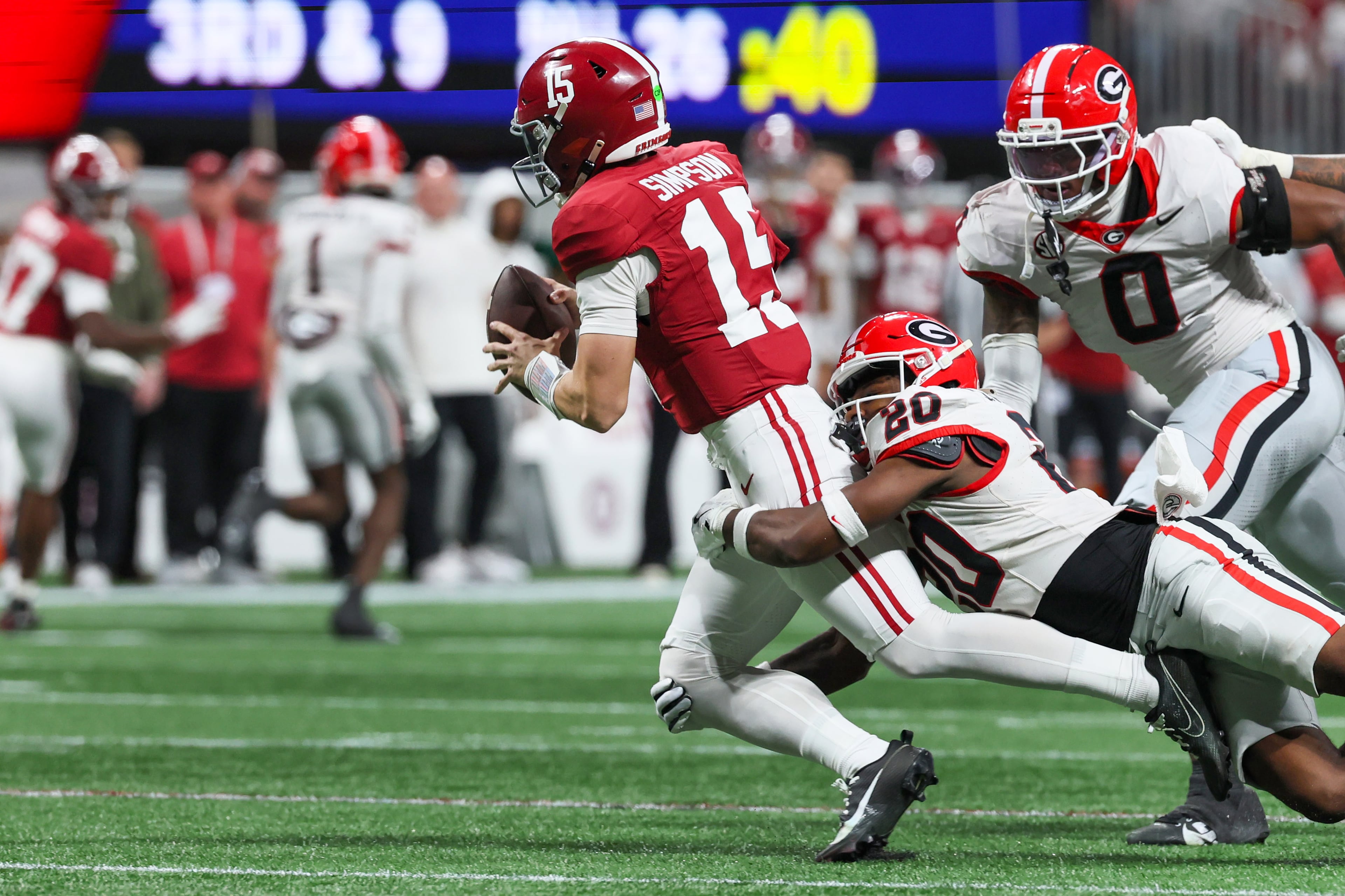 Alabama quarterback Ty Simpson (15) is sacked by Georgia defensive back JaCorey Thomas (20) during the third quarter of the SEC Championship game at Mercedes-Benz Stadium, Saturday, Dec. 6, 2025, in Atlanta. (Jason Getz / AJC)