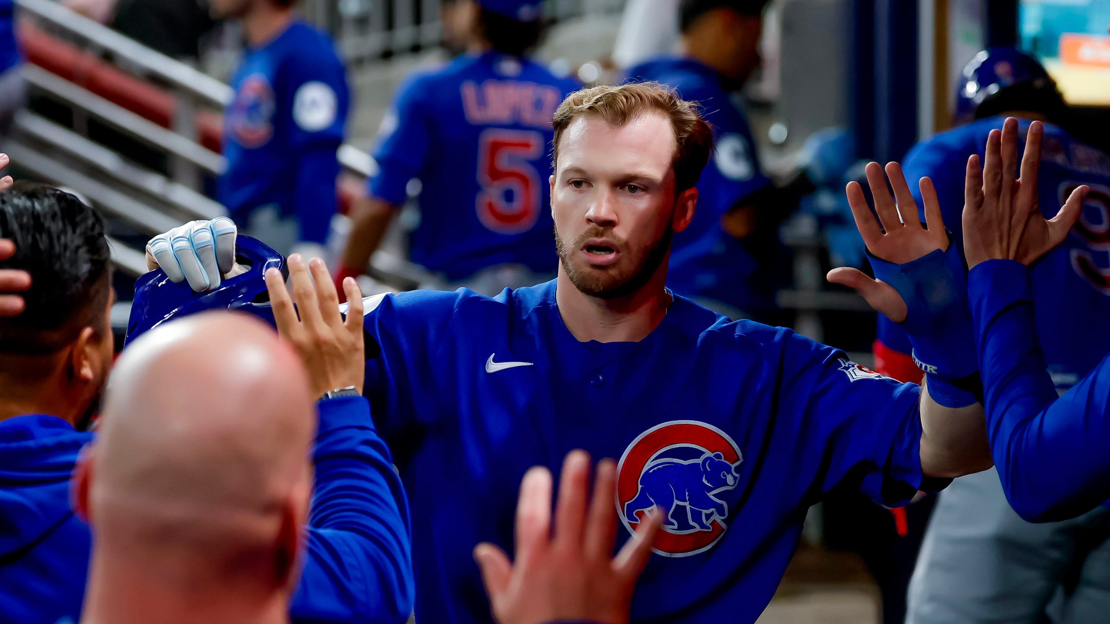 Chicago Cubs' Ian Happ is greeted in the dugout after scoring against the Atlanta Braves during the sixth inning of a baseball game, Thursday, May 14, 2026, in Atlanta. (AP Photo/Erik S. Lesser)