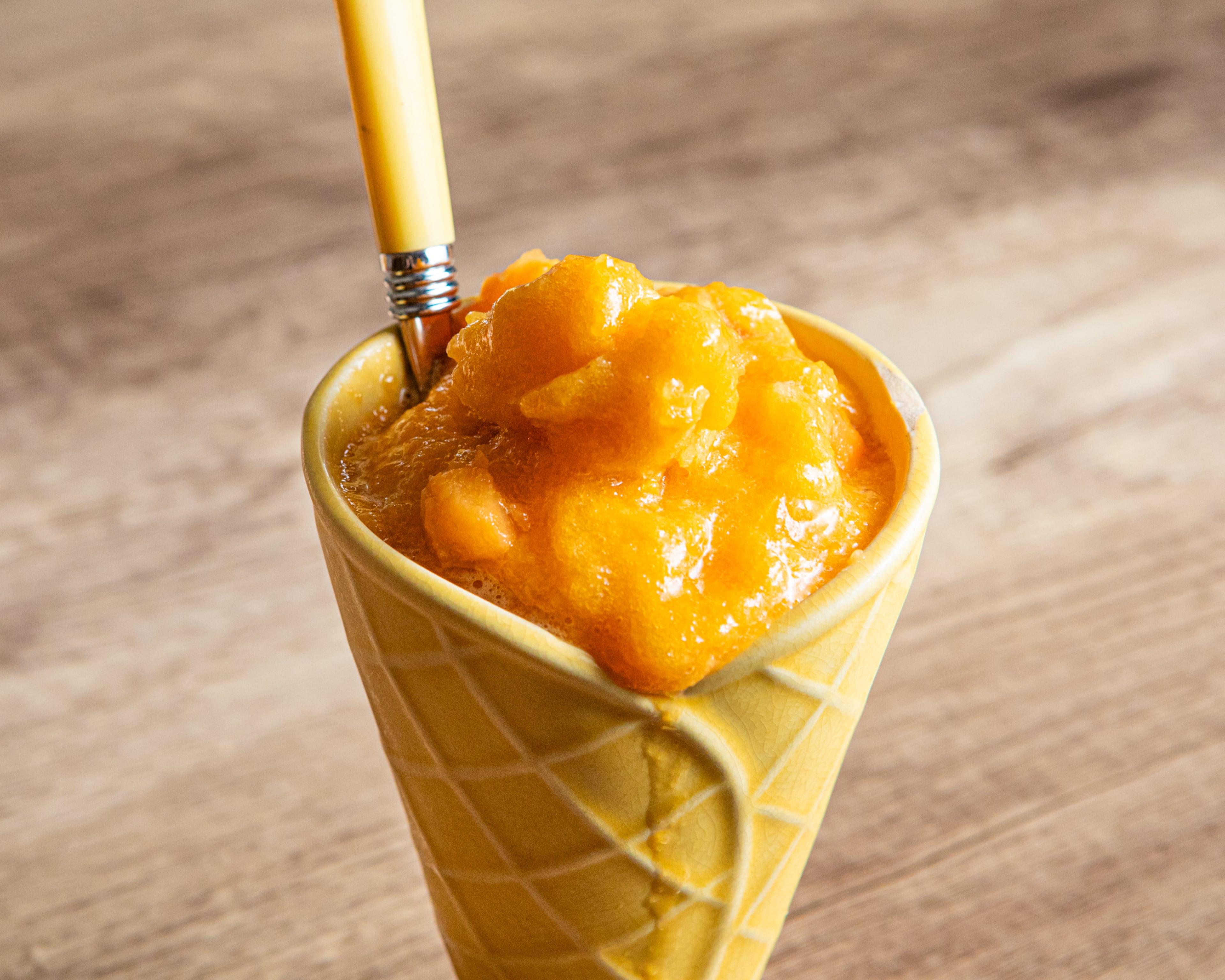 Roasted sweet potato pulp, orange juice and brown sugar make a deliciously Southern-tasting summer sorbet, shown here in a ceramic dish shaped like a waffle cone. (Aaliyah Man for The AJC/Food styling by Jennifer Hill Booker)