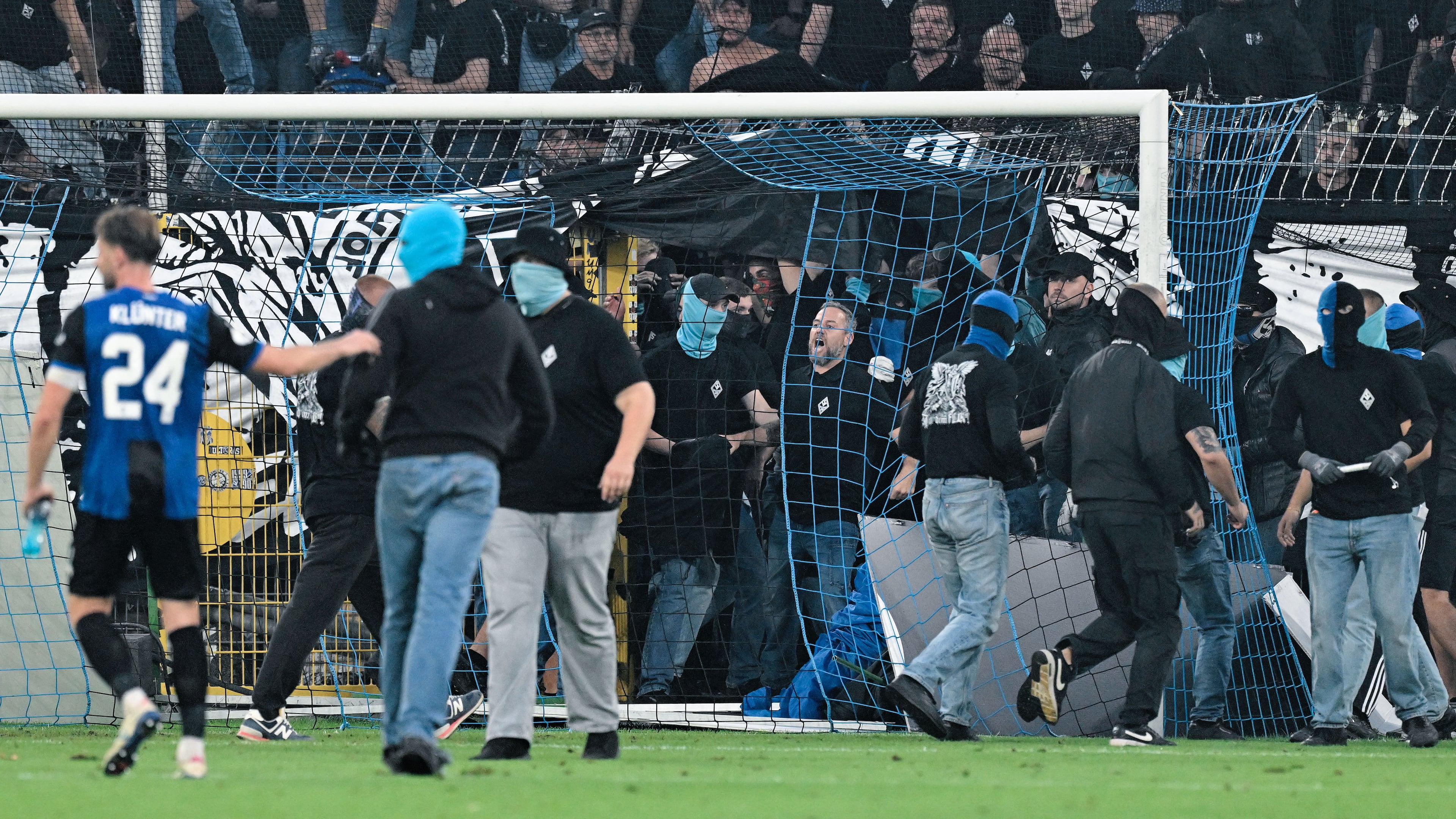 SV Mannheim supporters storm the field during the Germany Cup soccer match between SV Waldhof Mannheim and 1. FC Kaiserslautern, Friday, Aug. 21, 2026, in Mannheim, Germany. (Uwe Anspach/dpa via AP)