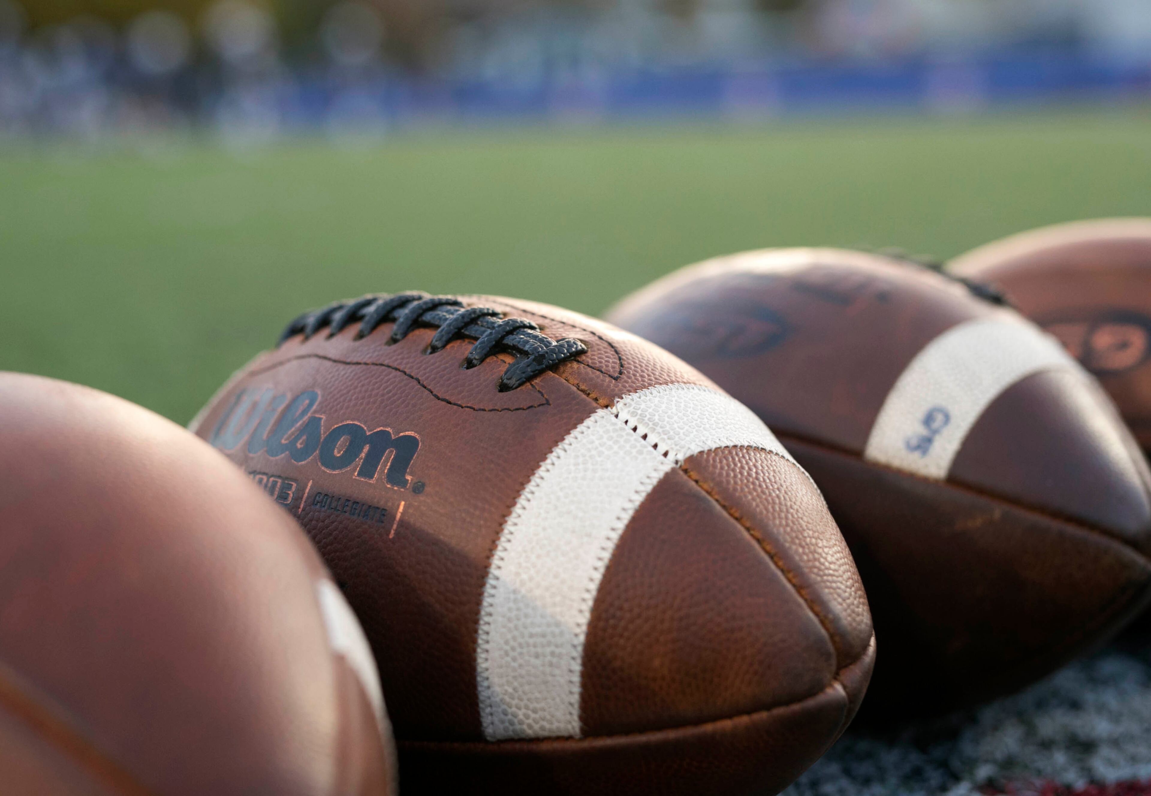Four footballs are shown at midfield before the game between Walton and Woodstock at Walton High School Friday, November 3, 2017, in Marietta. PHOTO / JASON GETZ