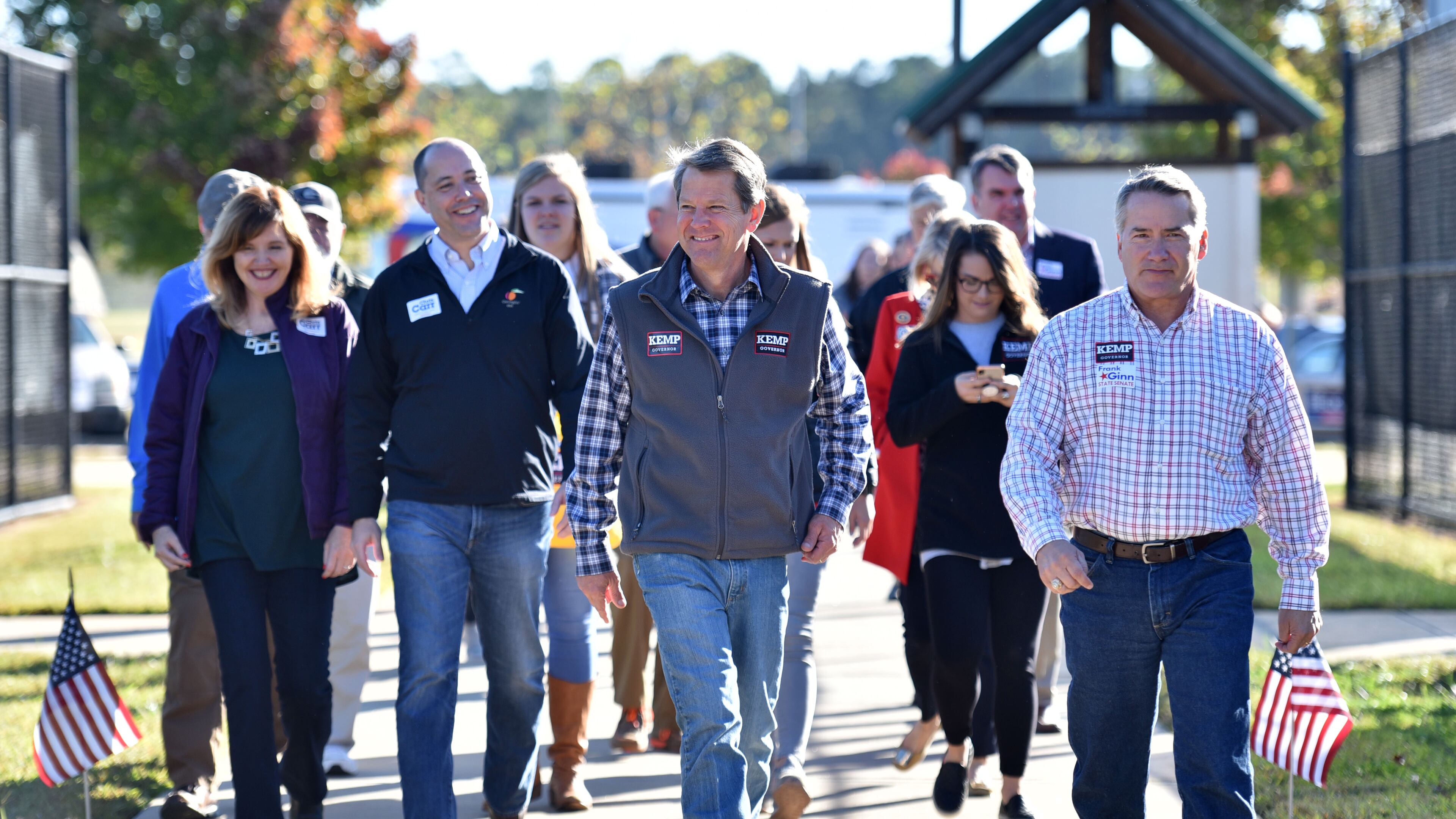 Brian Kemp (center) arrives at an event with other statewide Republican candidates and local elected officials. HYOSUB SHIN / HSHIN@AJC.COM