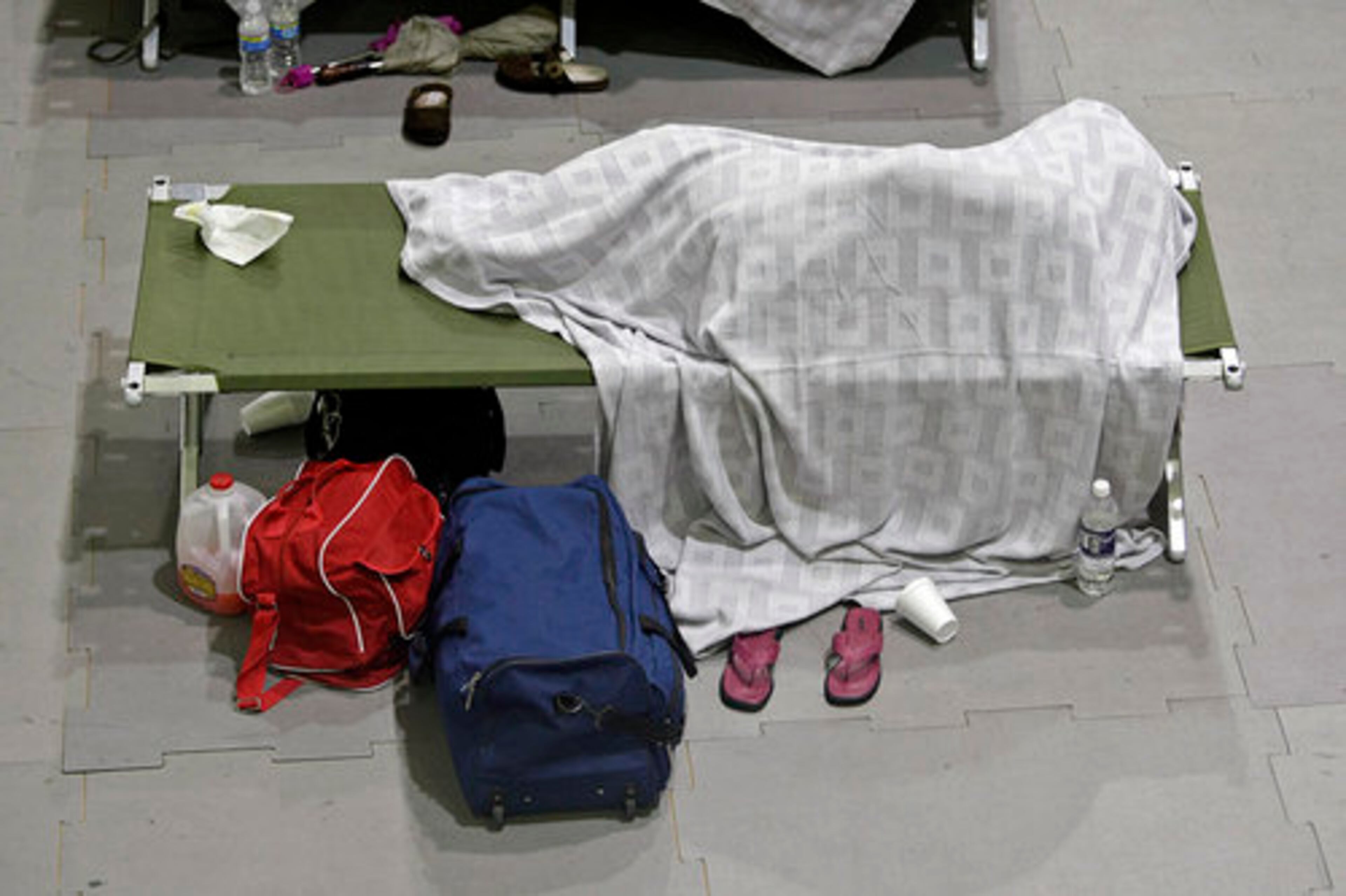 One of more than 72 flood victims from Douglas and Cobb County trys to get some sleep Monday night at the American Red Cross disaster center inside the Cobb County Civic Center.